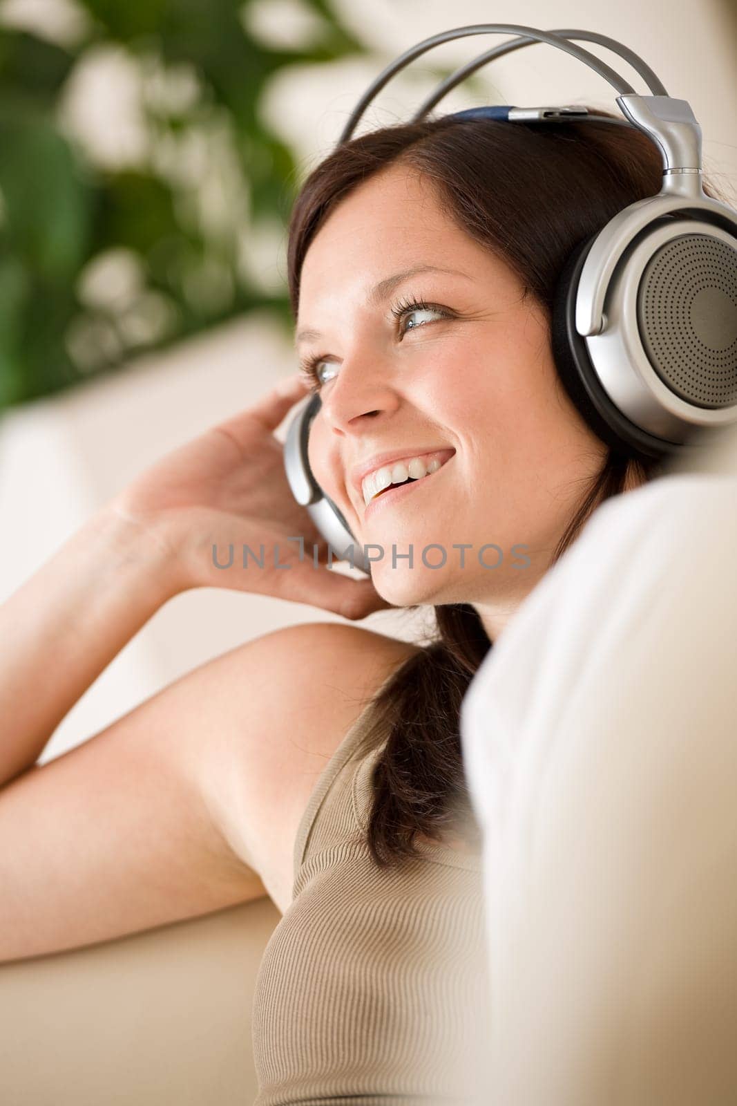 Woman with headphones listen to music in lounge