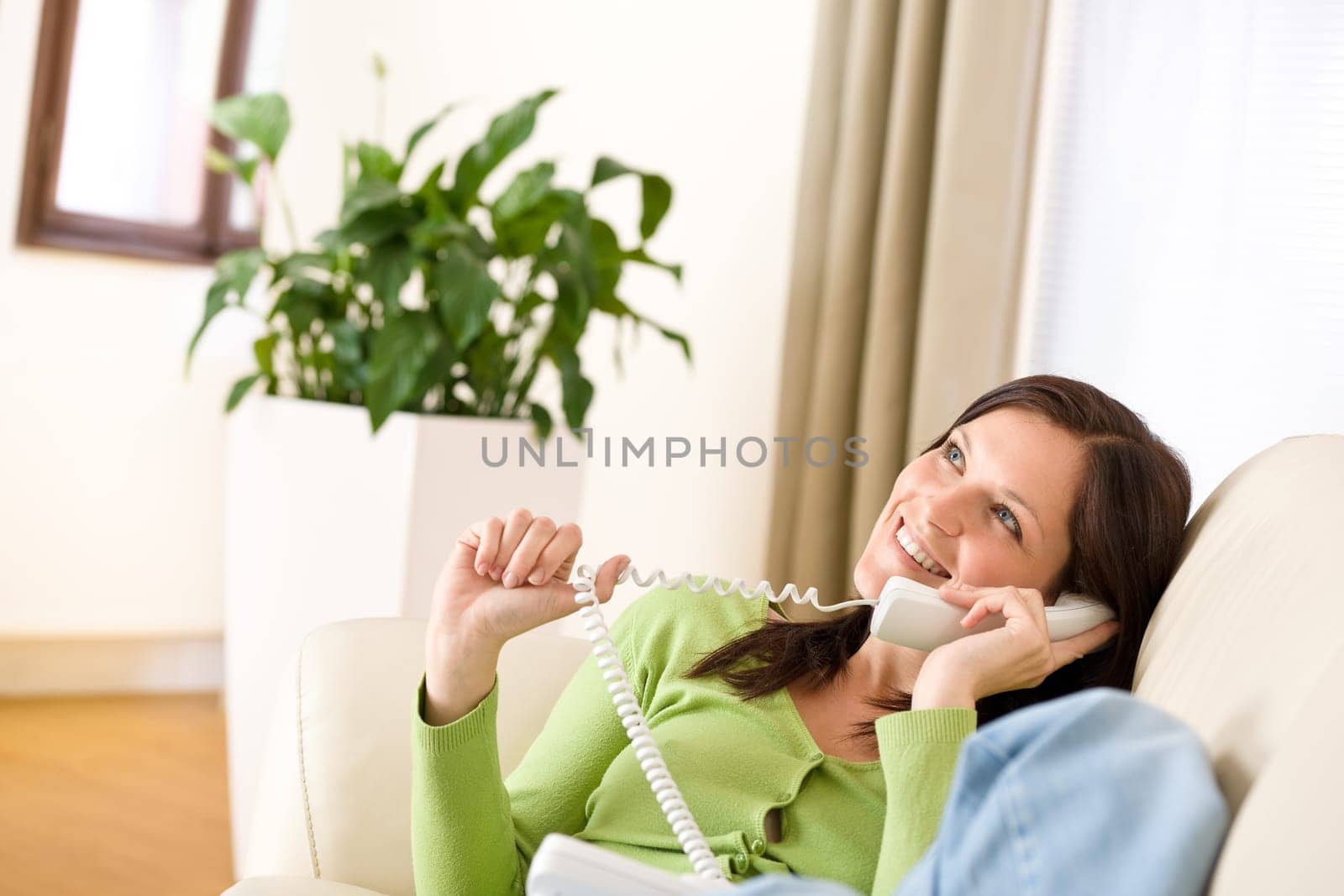 On the phone home Smiling woman calling