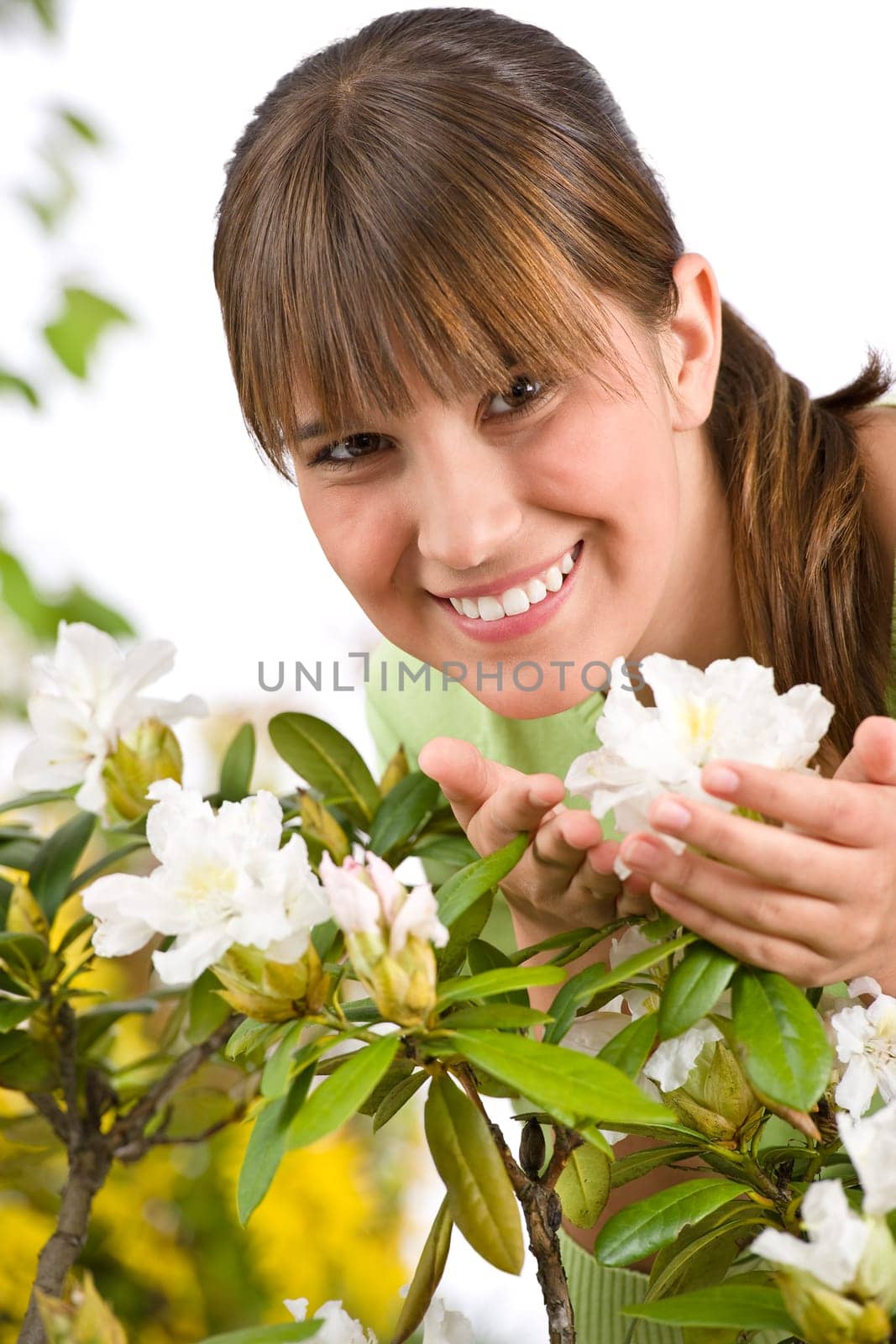 Gardening - Portrait of woman with Rhododendron flower