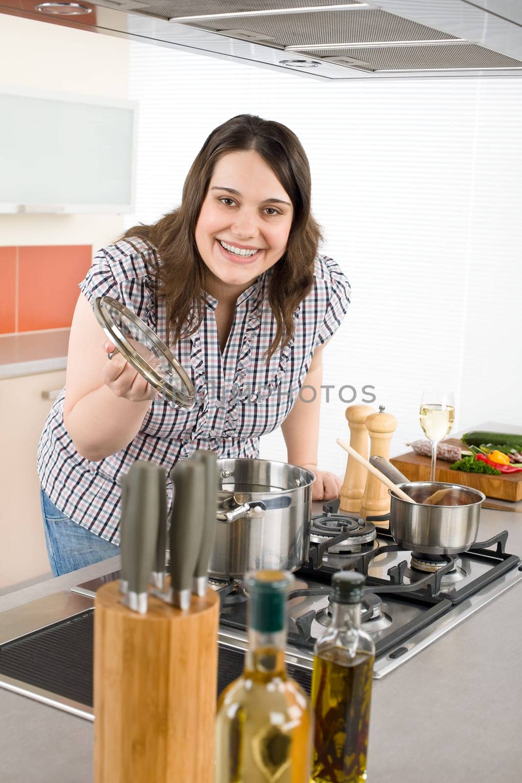 Cook - plus size woman in modern kitchen