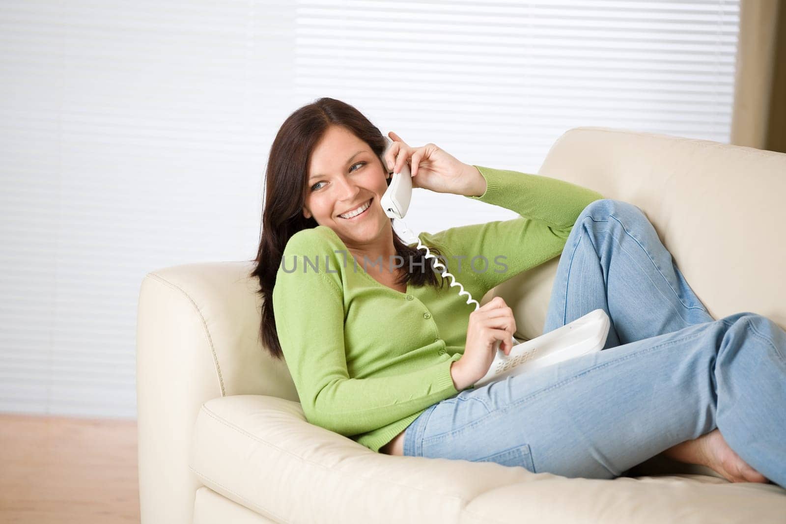 On the phone home Smiling woman calling