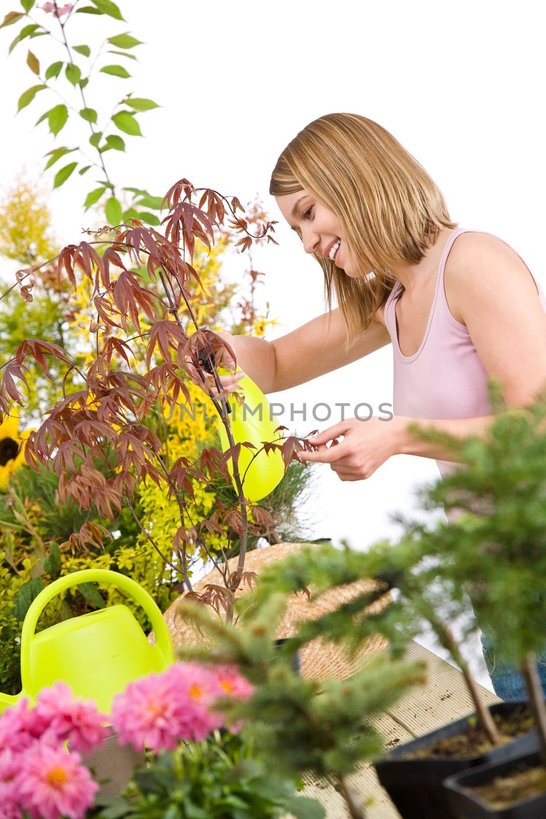 Gardening - woman sprinkling water to plant