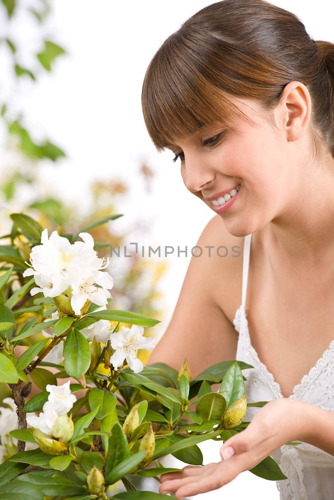 Gardening - Portrait of woman with Rhododendron flower
