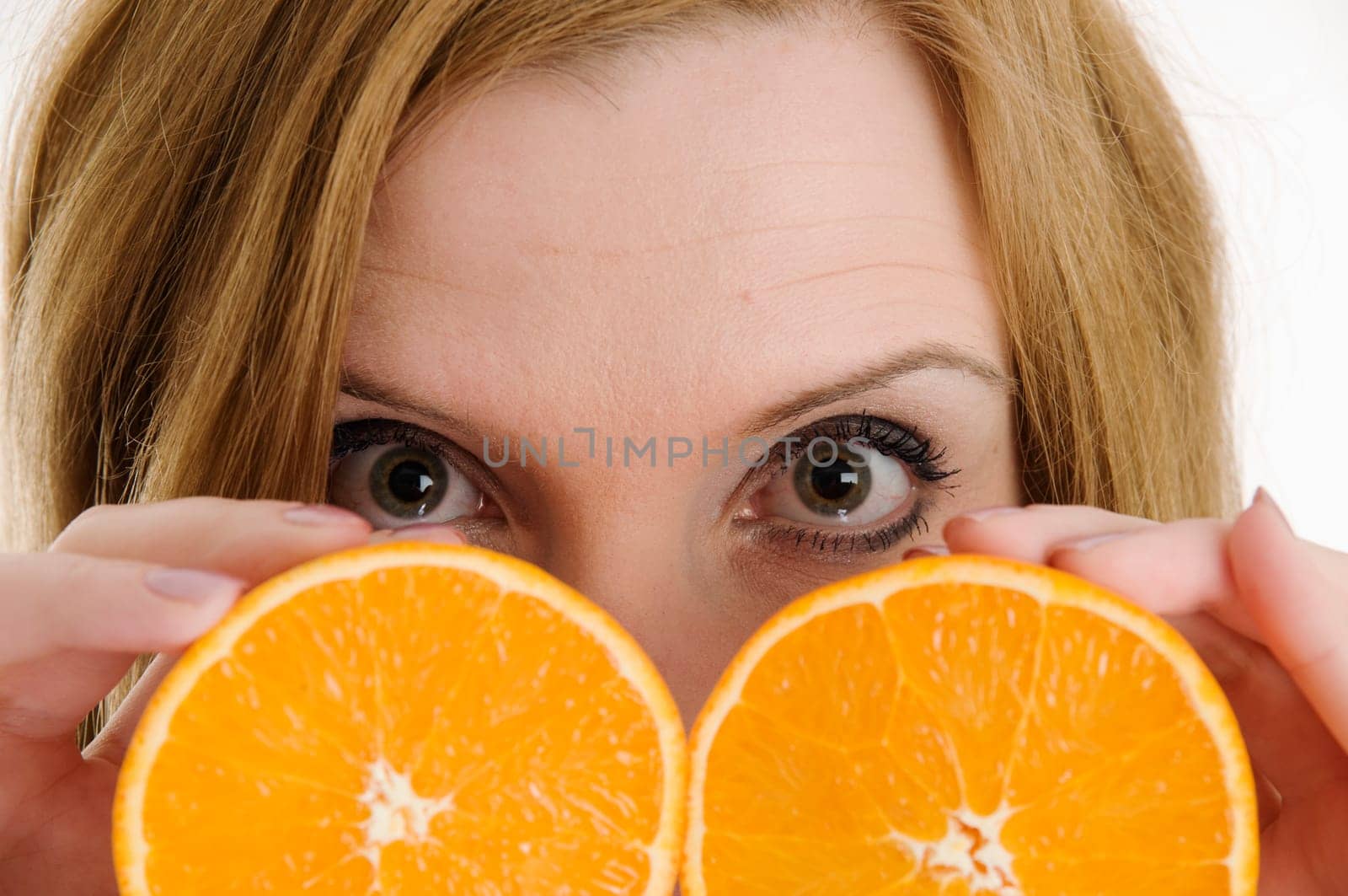 open eyes behind the oranges