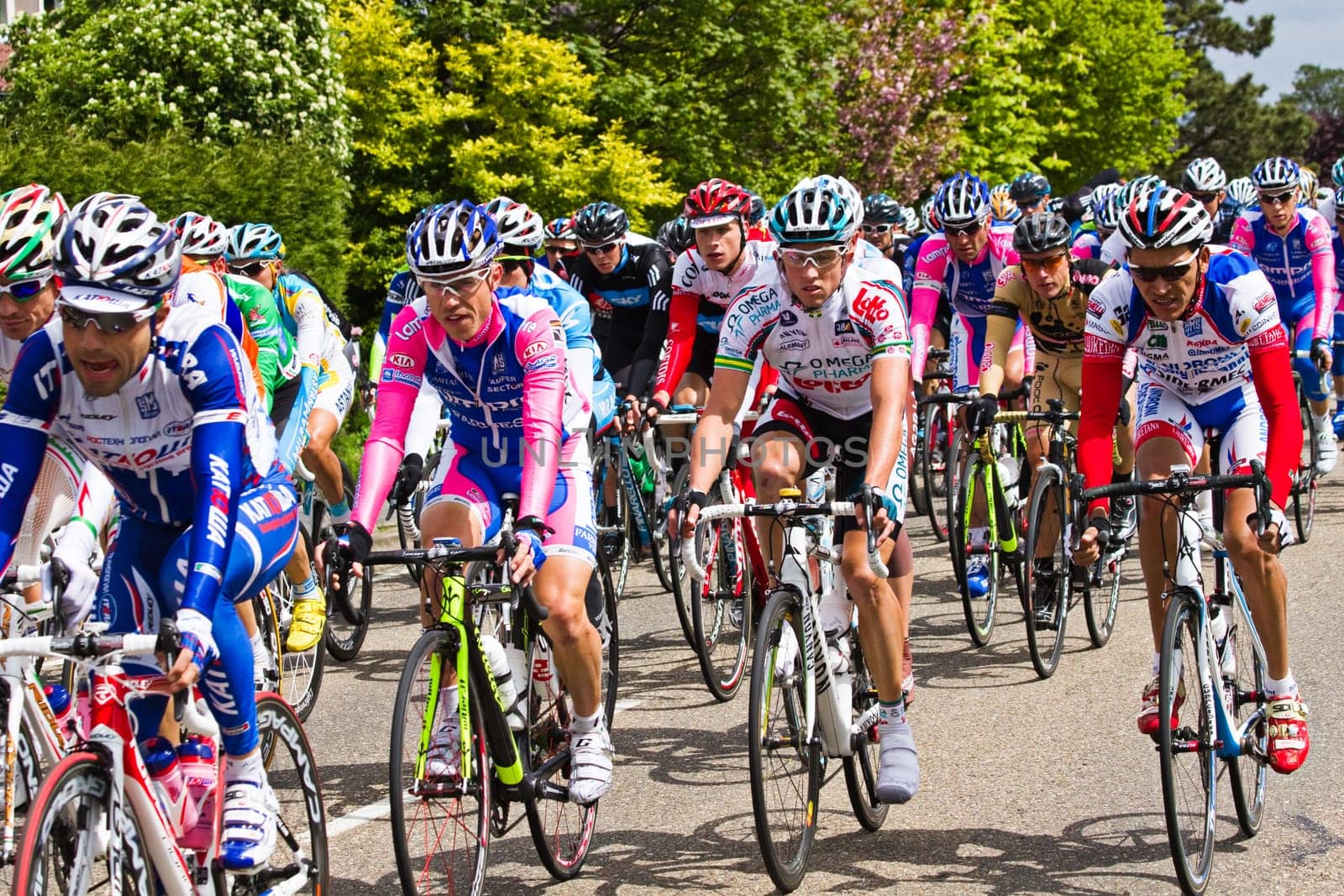 Competitors and following teams in the Giro dItalia passing by on a polderroad i