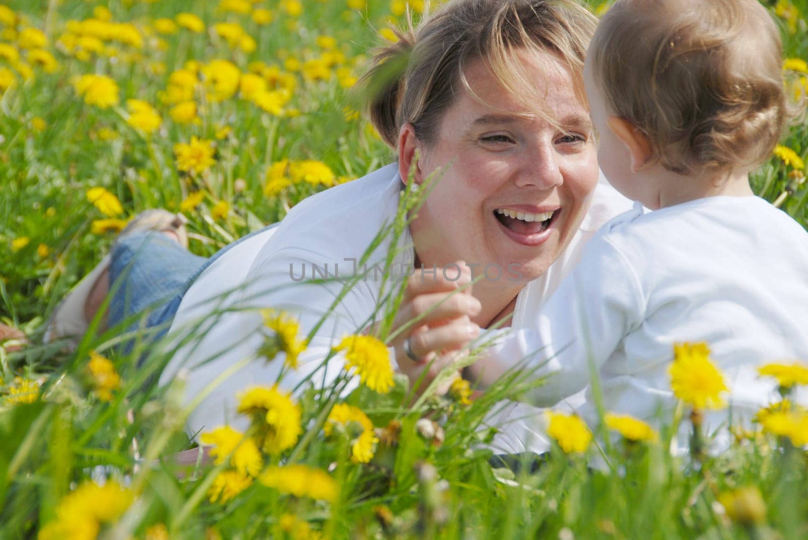 Mother with toddler in dandelion field