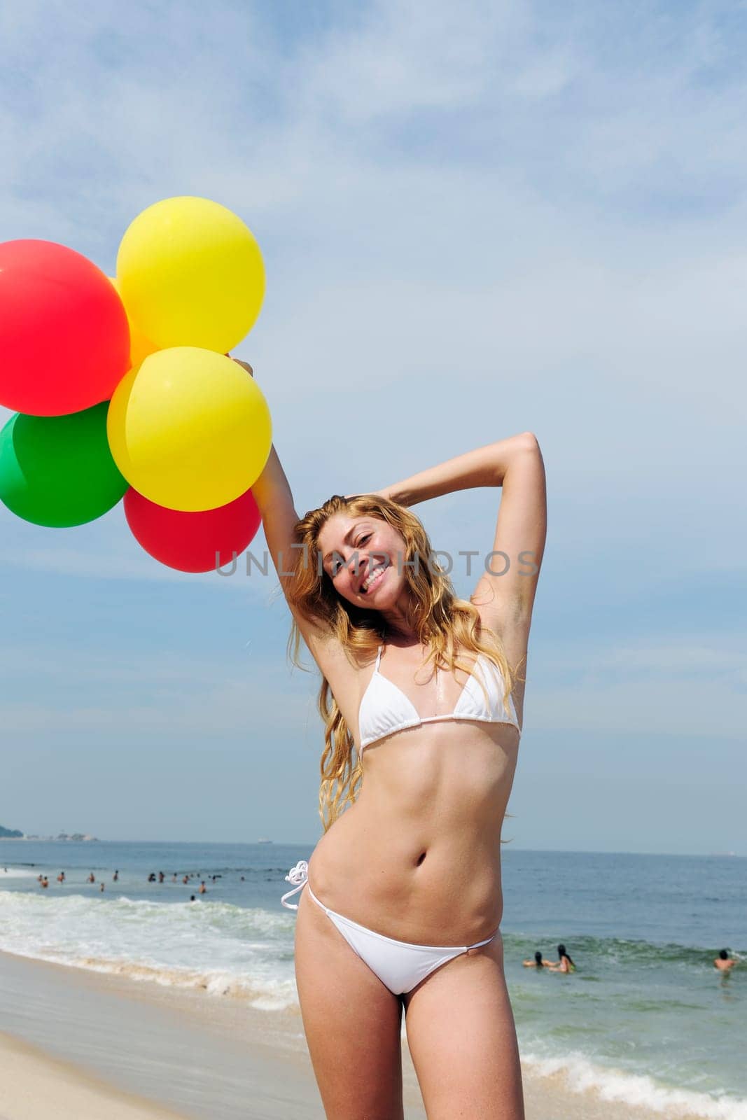Woman with balloons on the beach