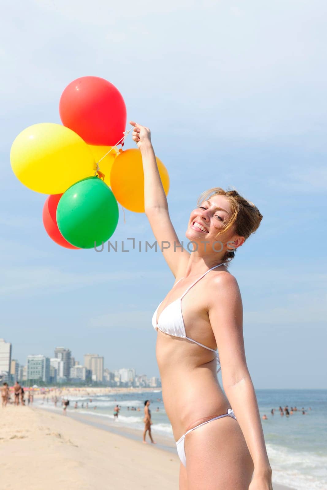 Woman with balloons on the beach
