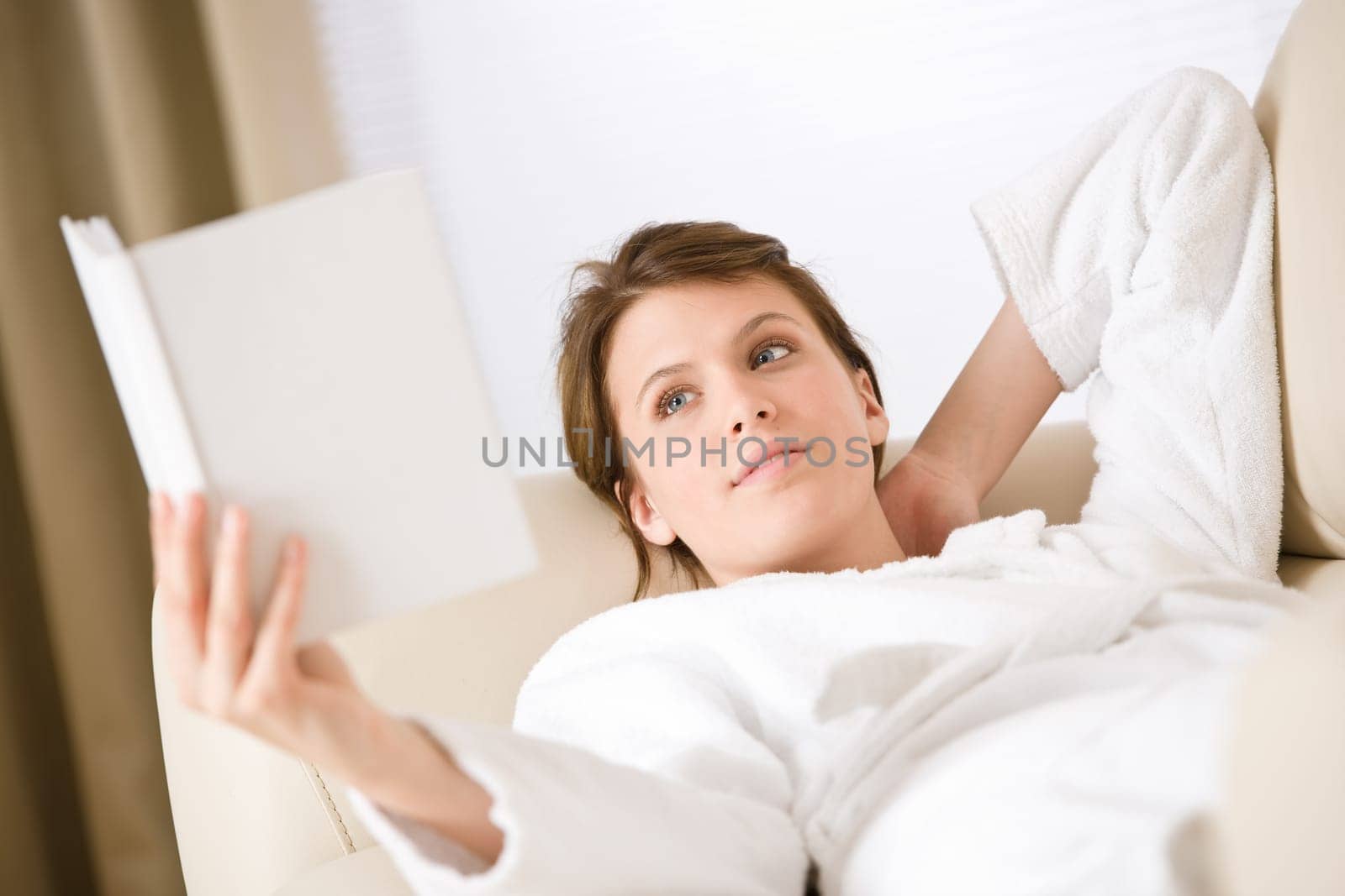 Young woman read book on sofa