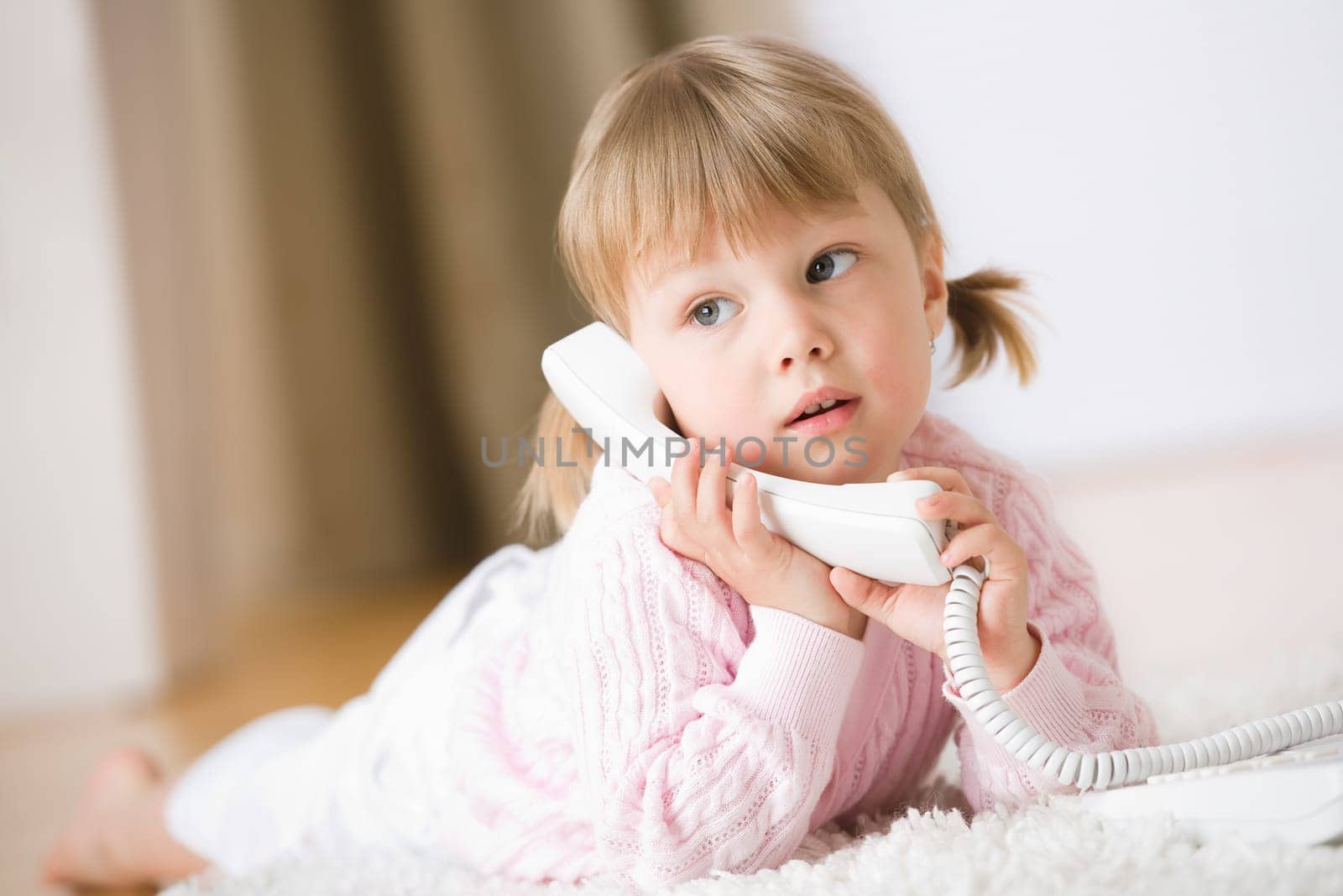 Smiling girl on the phone lying down