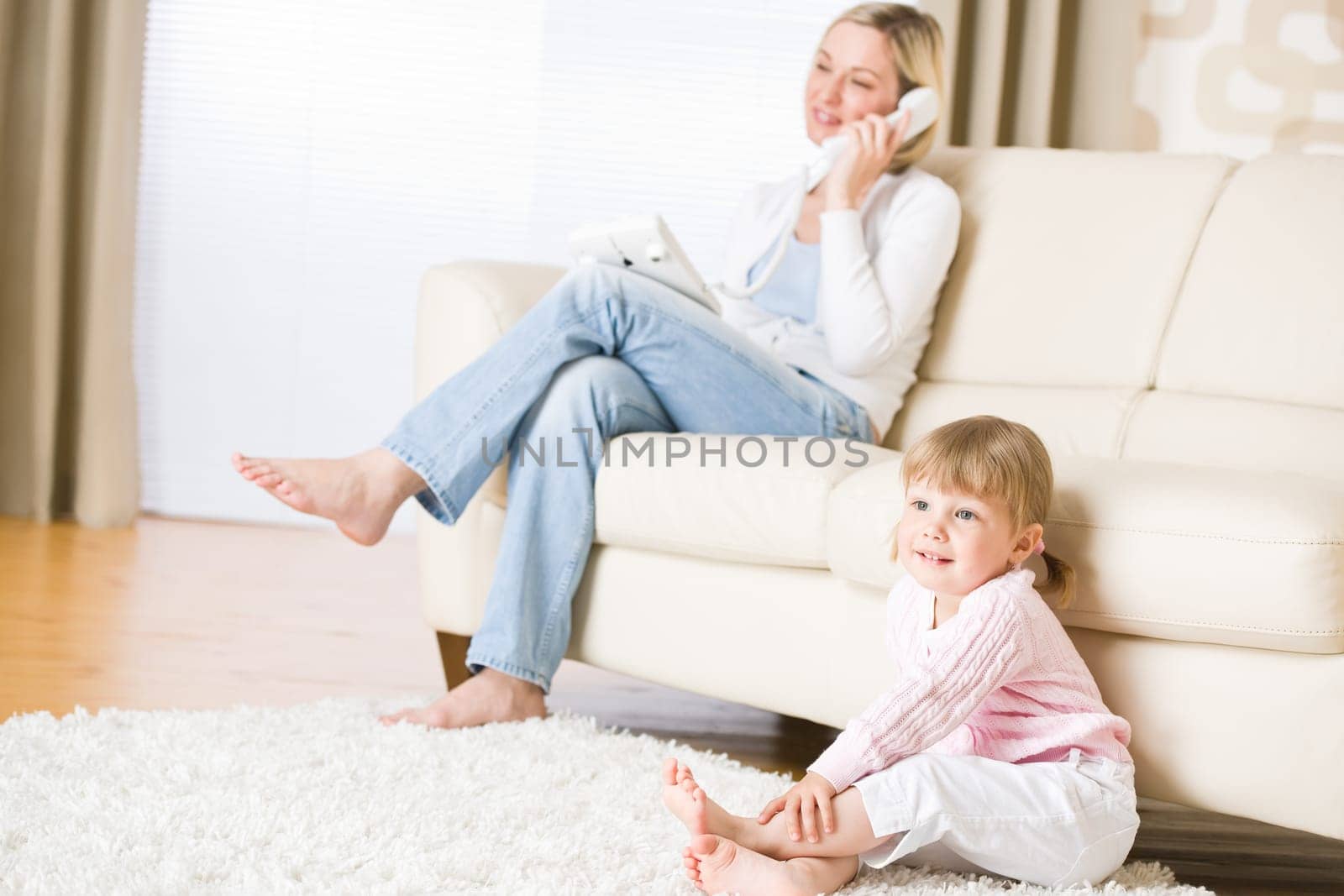 Mother and child in living room watch television