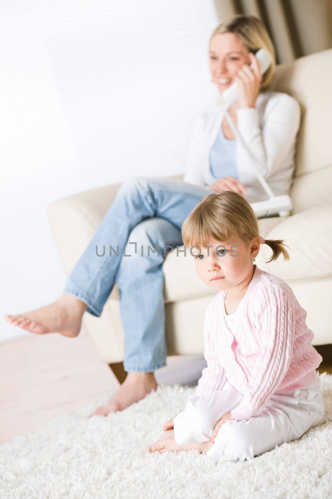 Mother and child in living room watch television