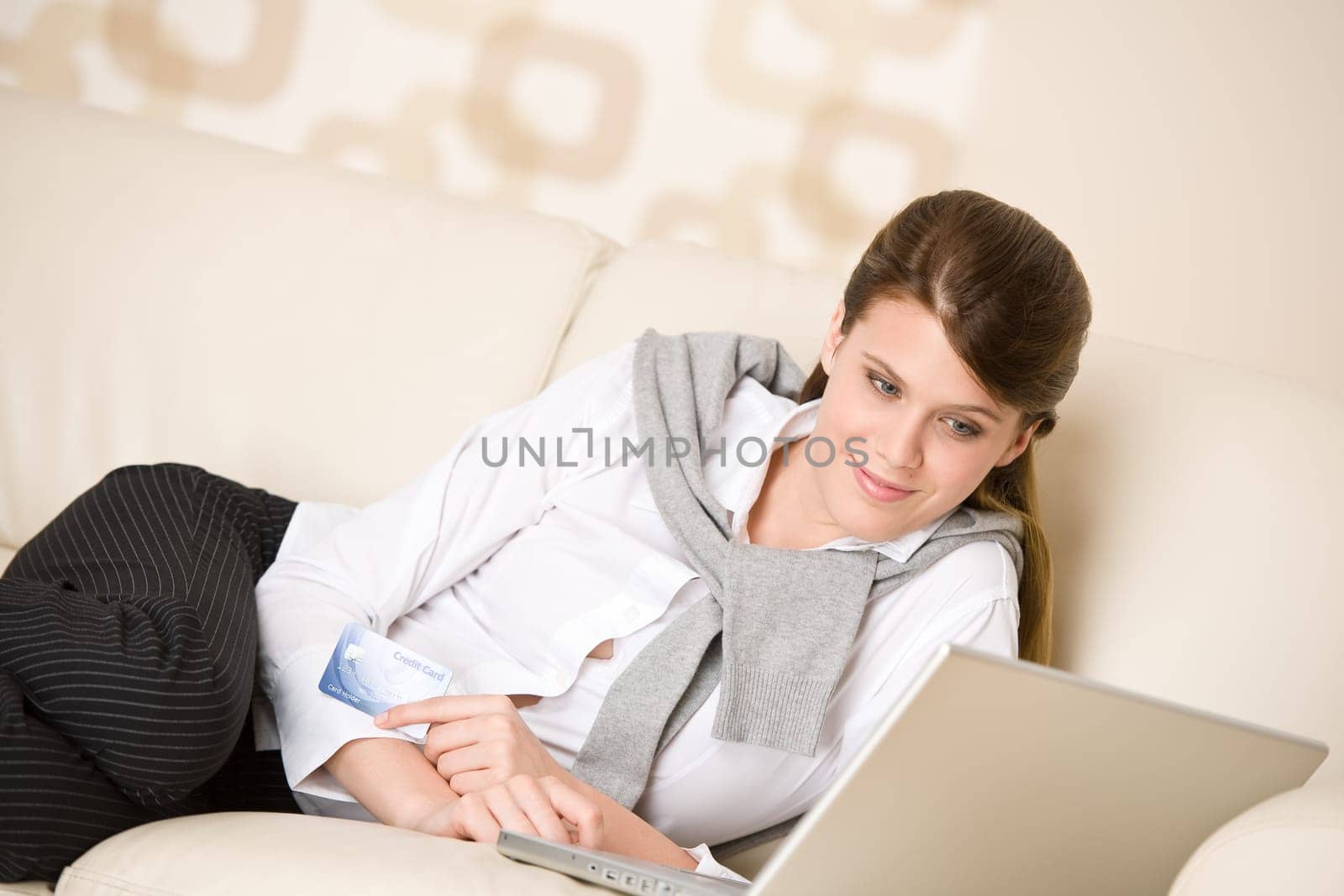 Home shopping - woman with credit card and laptop