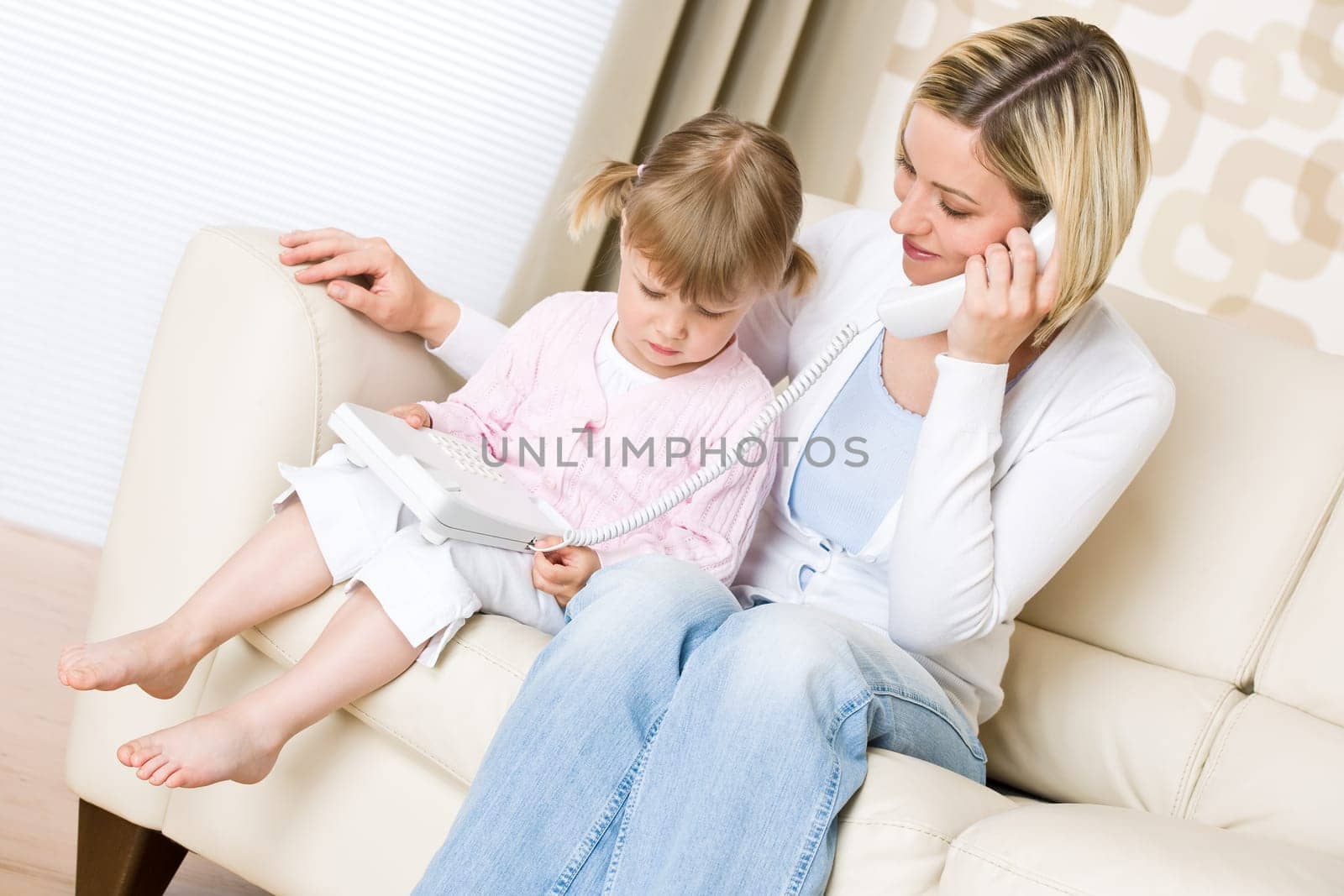 Mother and child - on the phone in living room