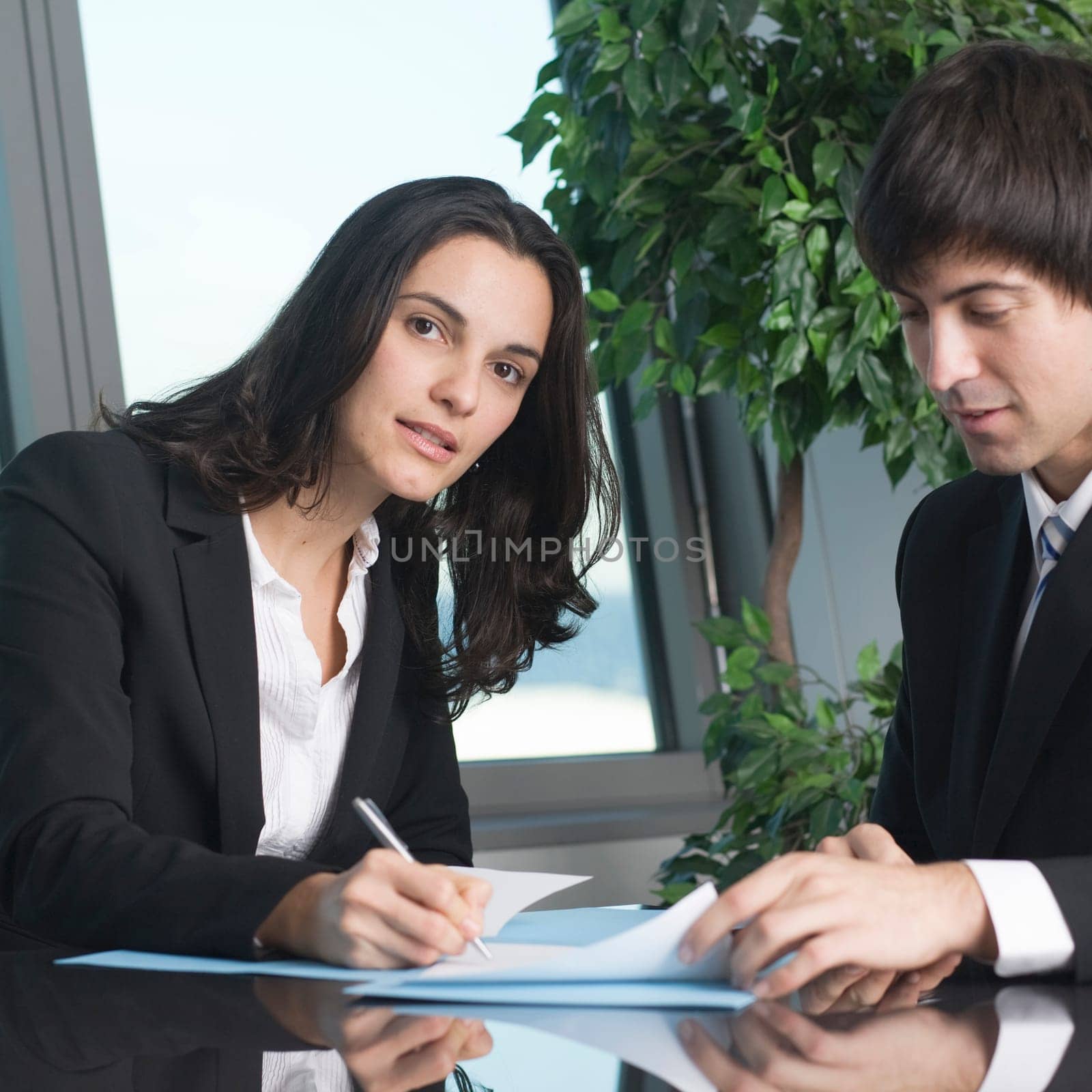 Businesswoman signs paperwork