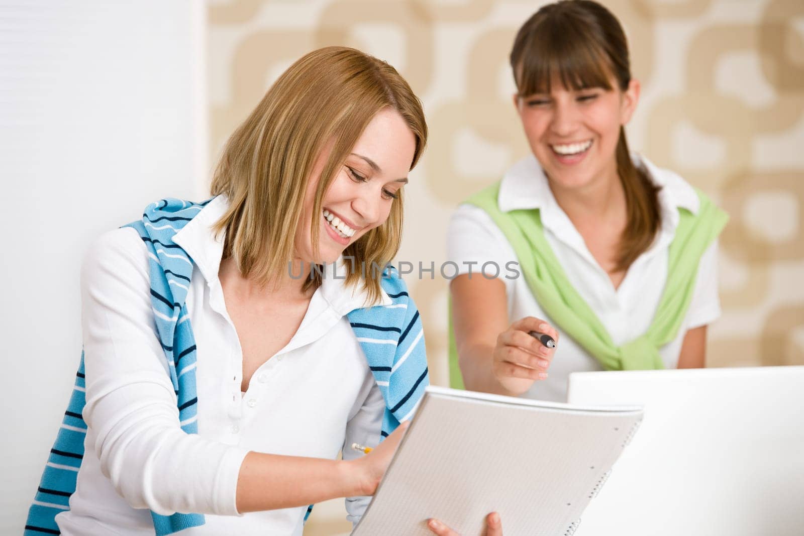 Student at home - two woman with book and laptop