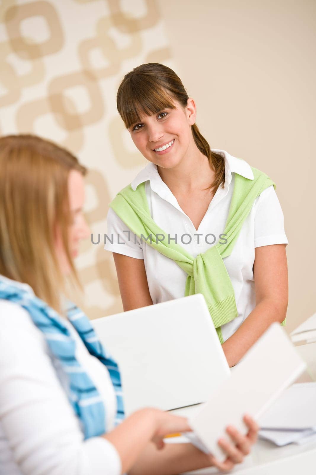 Student at home - two woman with book and laptop