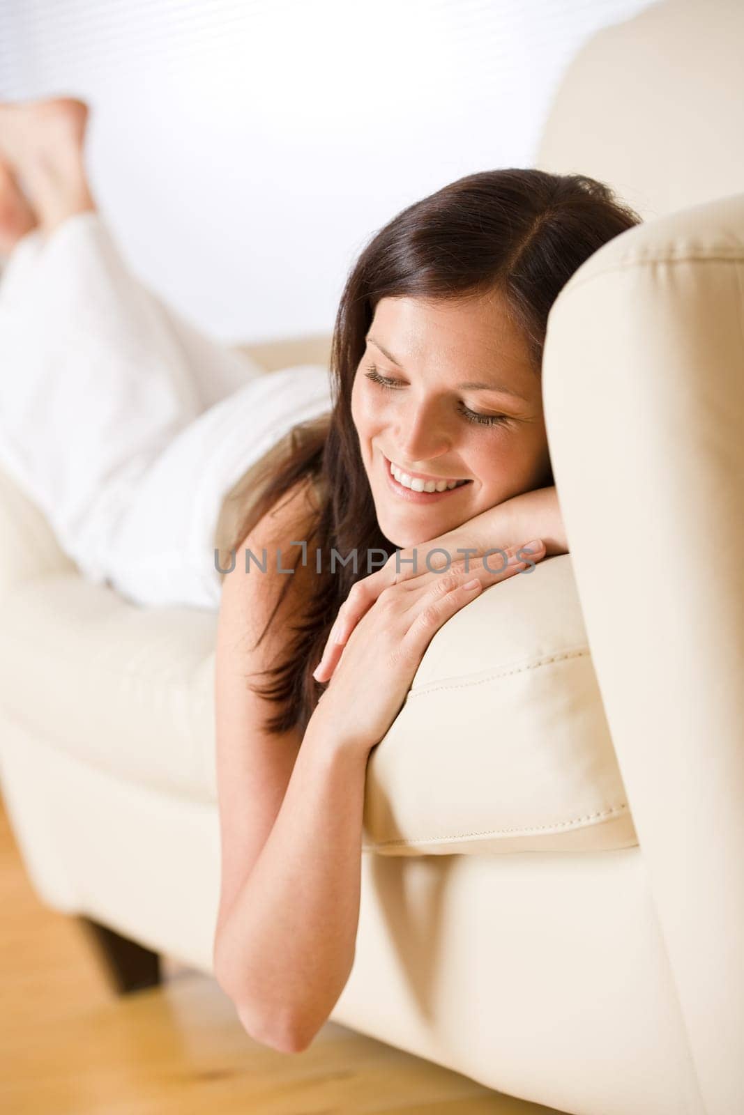 Thoughtful woman relax in lounge on sofa