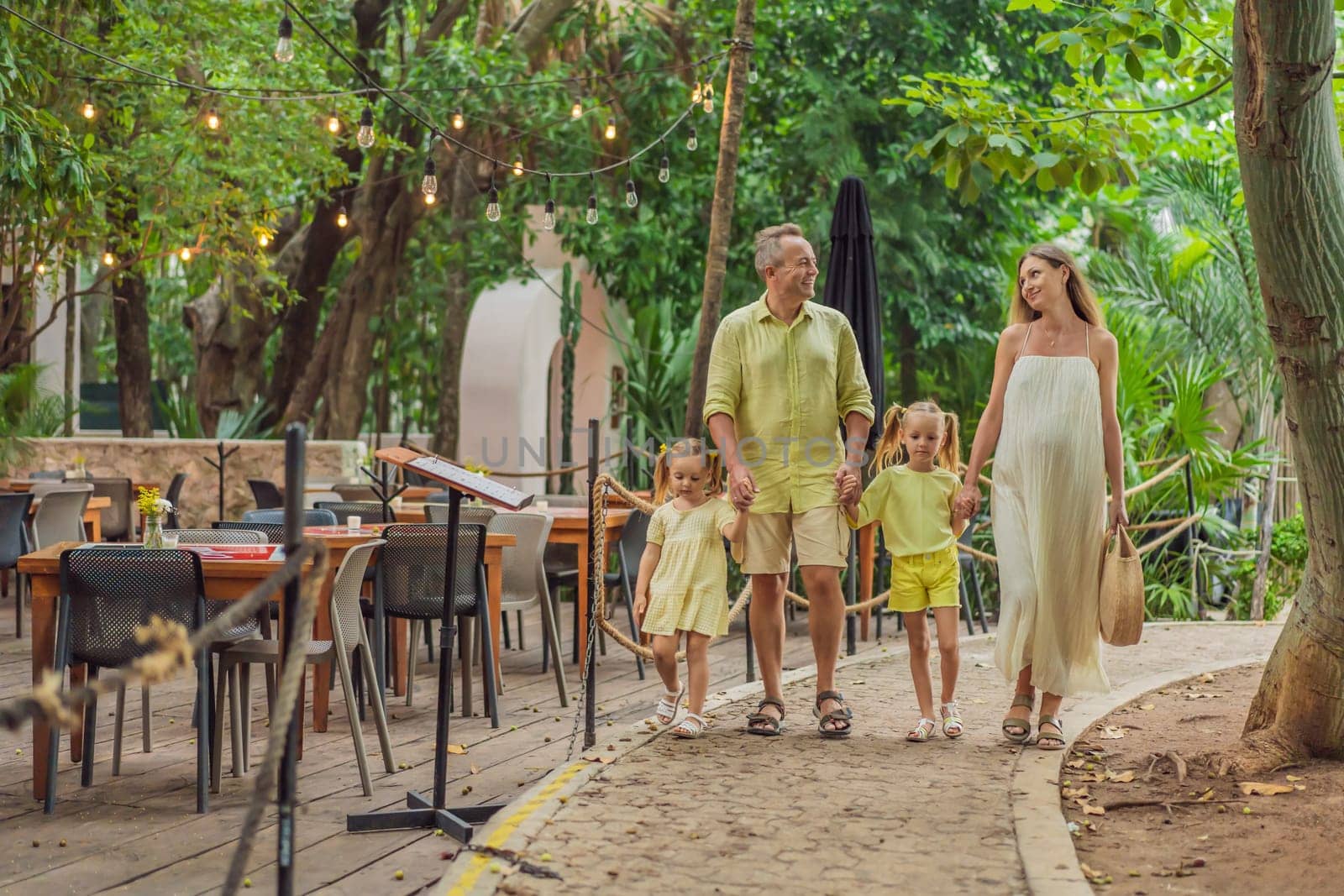 A joyful family, two girls, dad, and a pregnant mom, bask in tropical resort, celebrating a radiant pregnancy amidst paradise by galitskaya