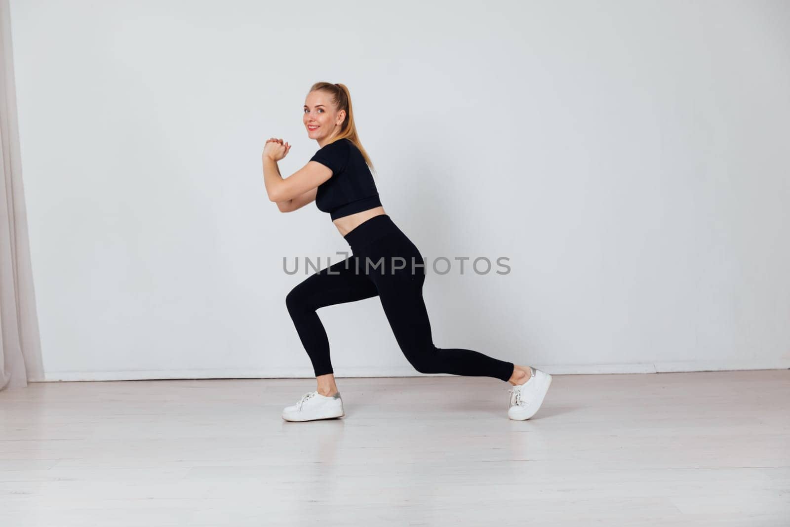 woman engaged in sports warm-up exercise gym by Simakov
