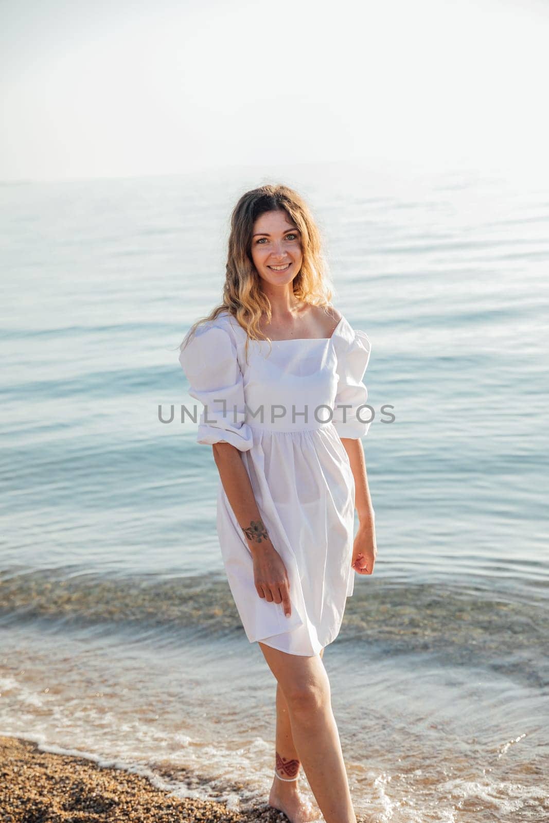 woman stands by the sea by the water on the beach rest walk