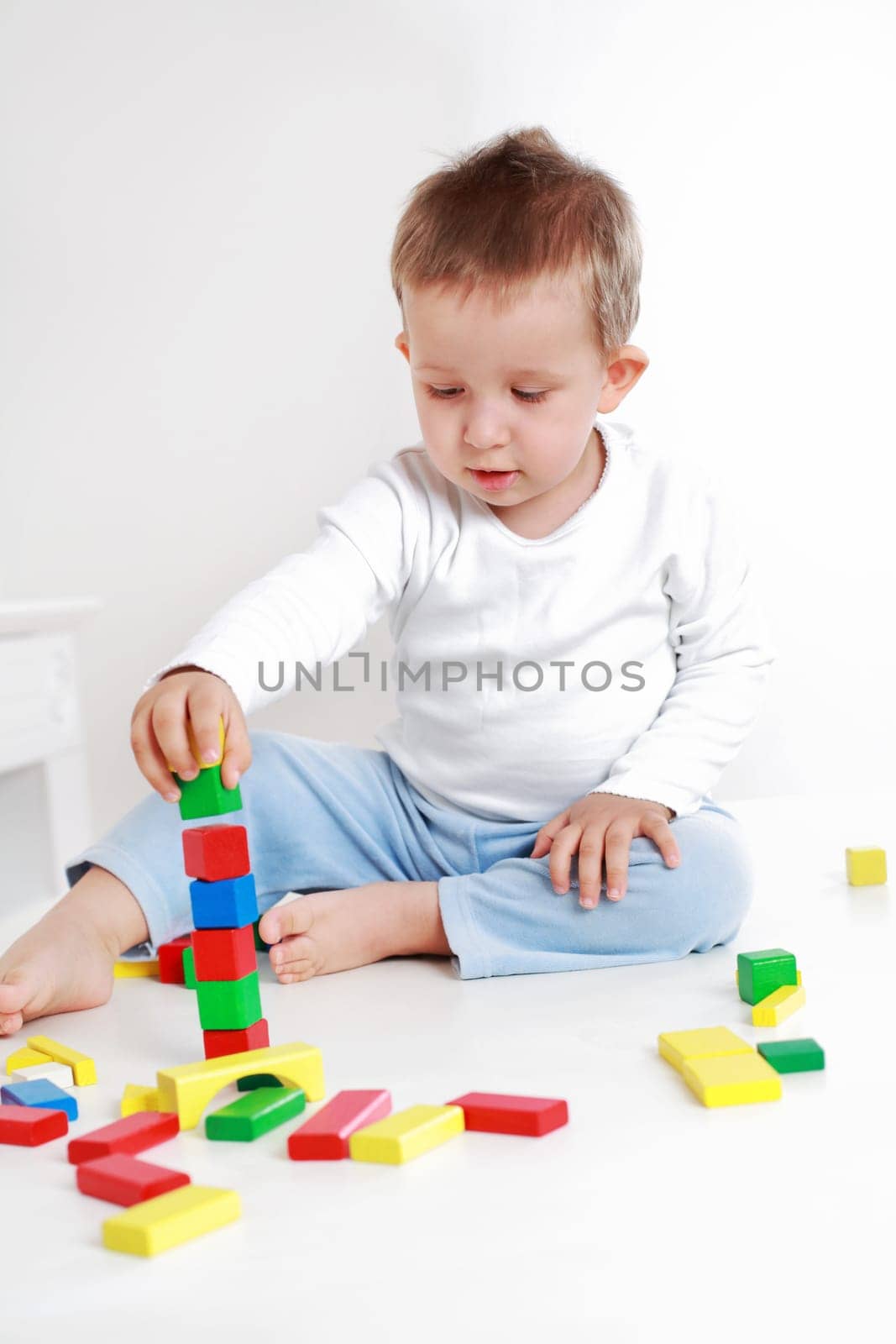Lovely boy playing with blocks