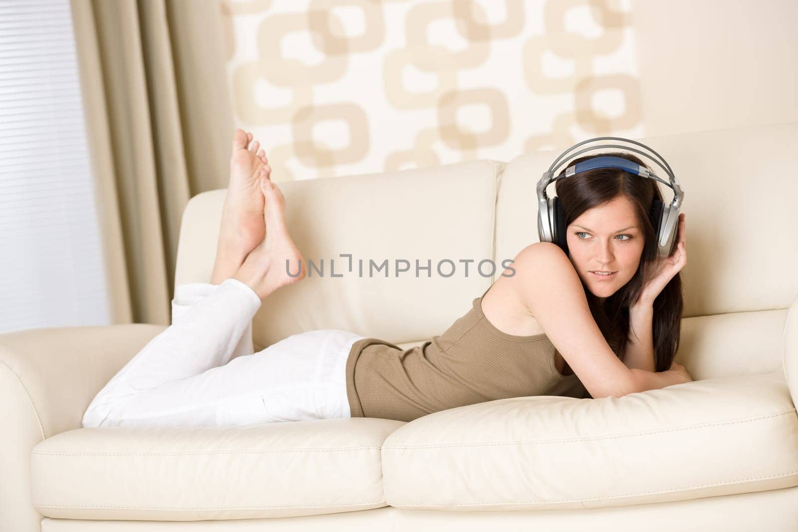 woman with headphones listen to music in lounge