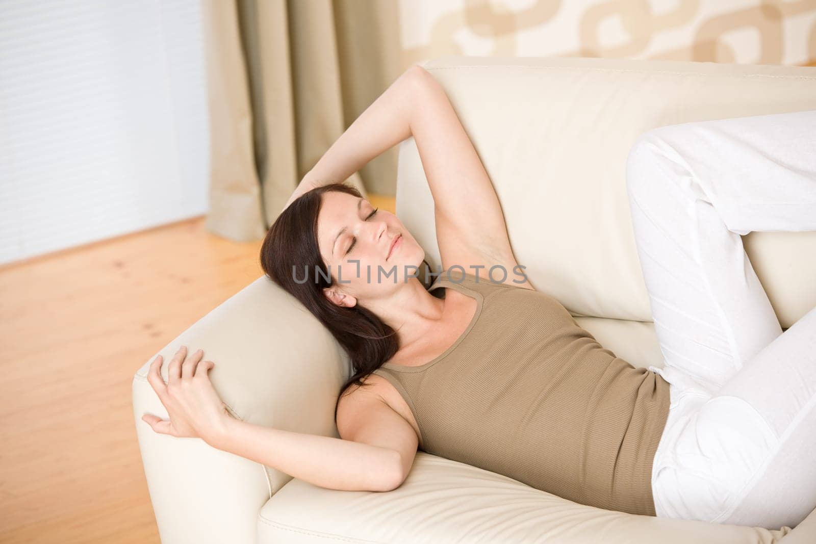 Young woman relax lying down on sofa