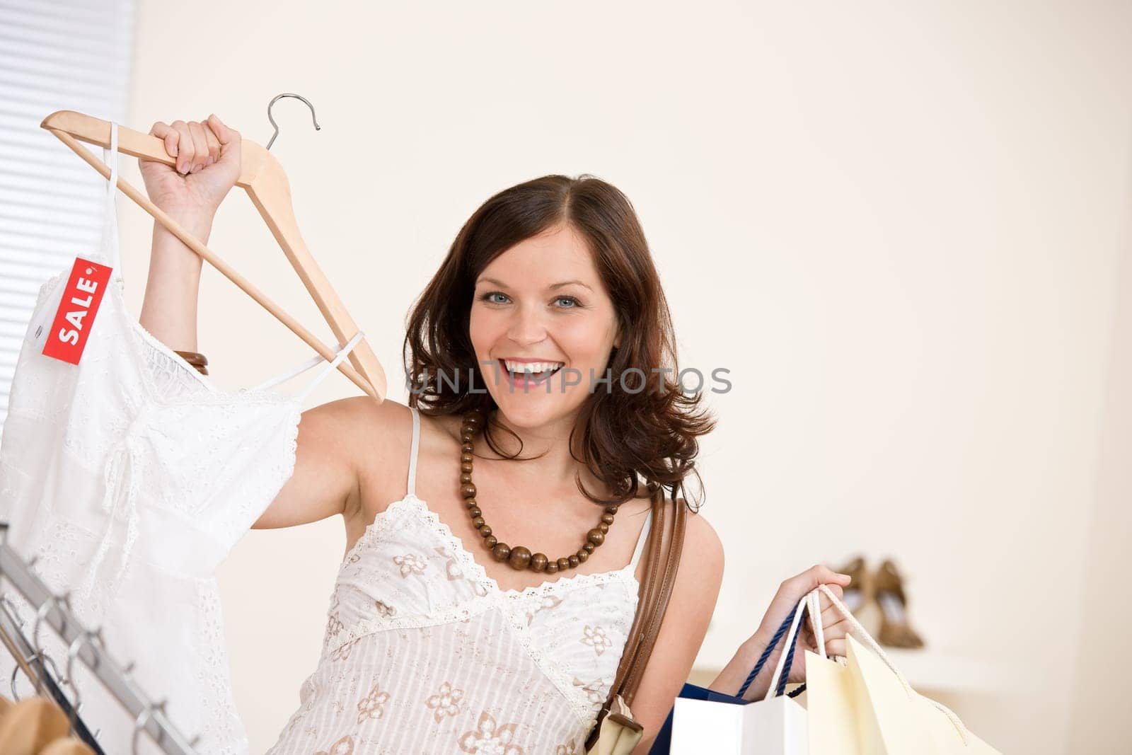Fashion shopping - Happy woman choose sale clothes
