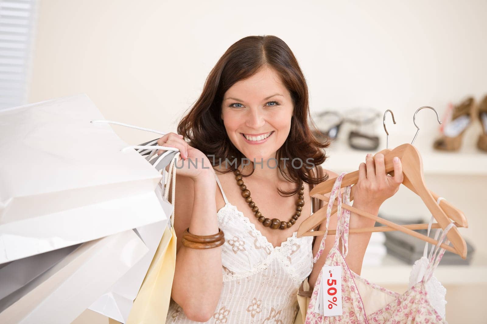 Fashion shopping - Happy woman choose sale clothes