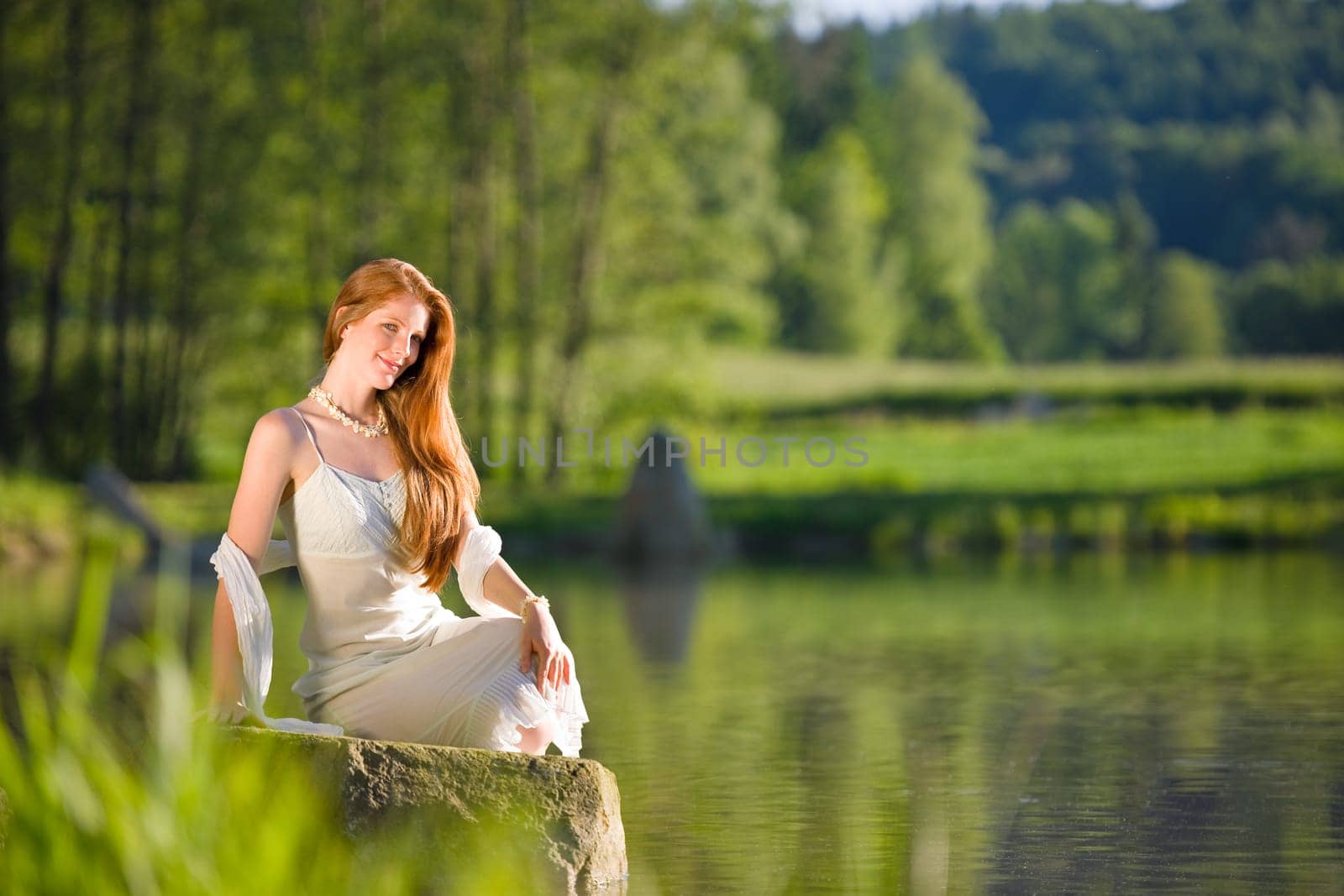 Long red hair romantic woman relax by lake