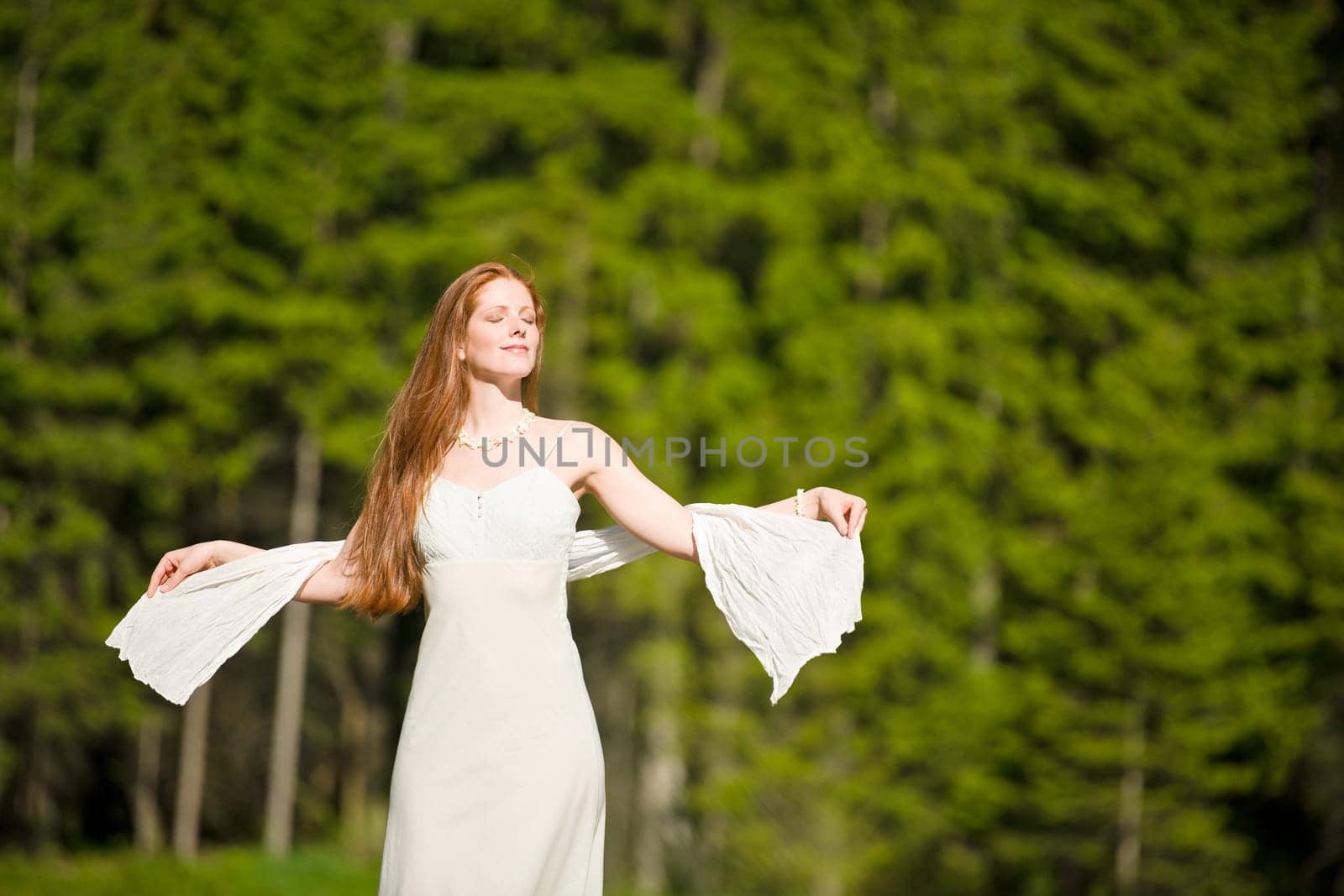 Long red hair romantic woman by lake
