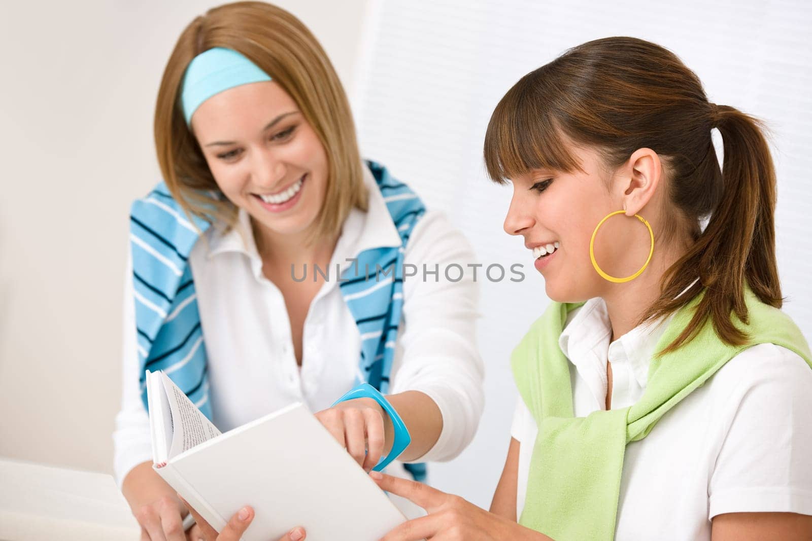Student at home - two young woman study together