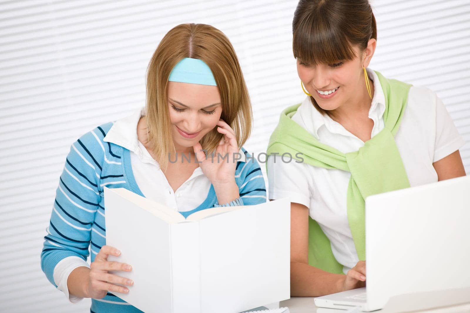 Student at home - two young woman study together