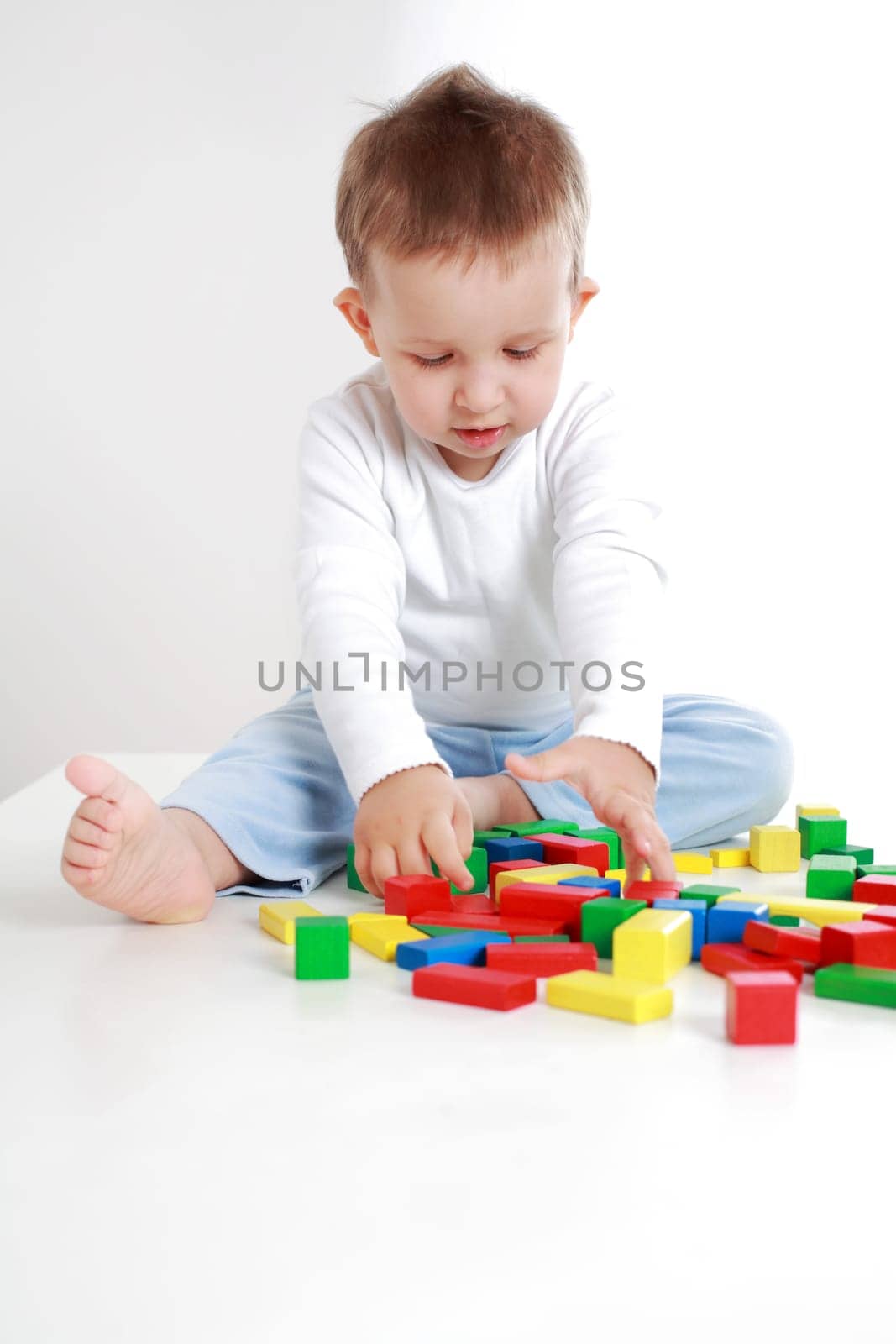 Lovely boy playing with blocks
