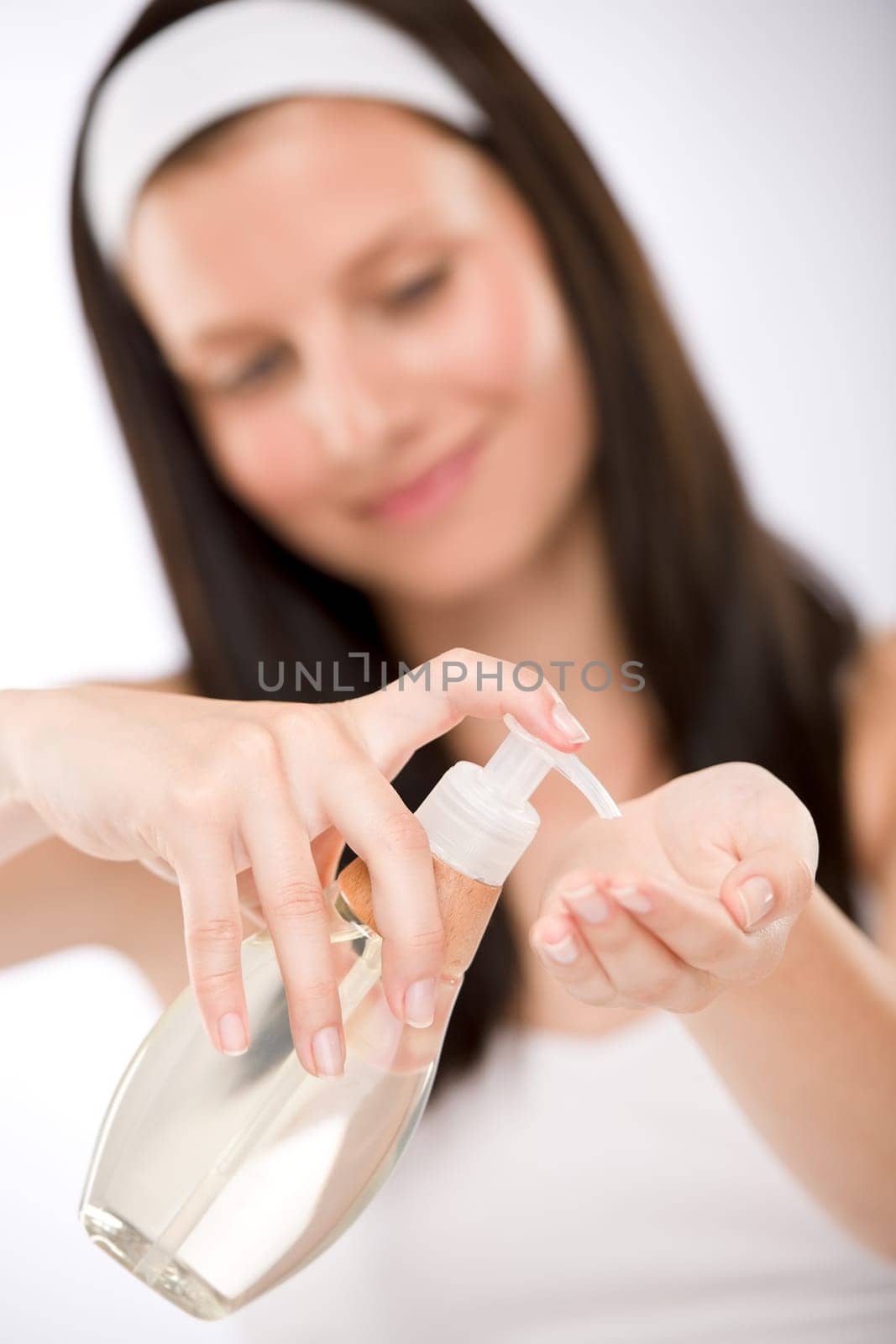 Body care - woman applying massage oil
