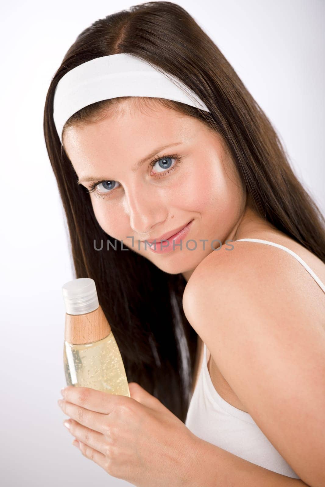 Body care - woman holding shampoo