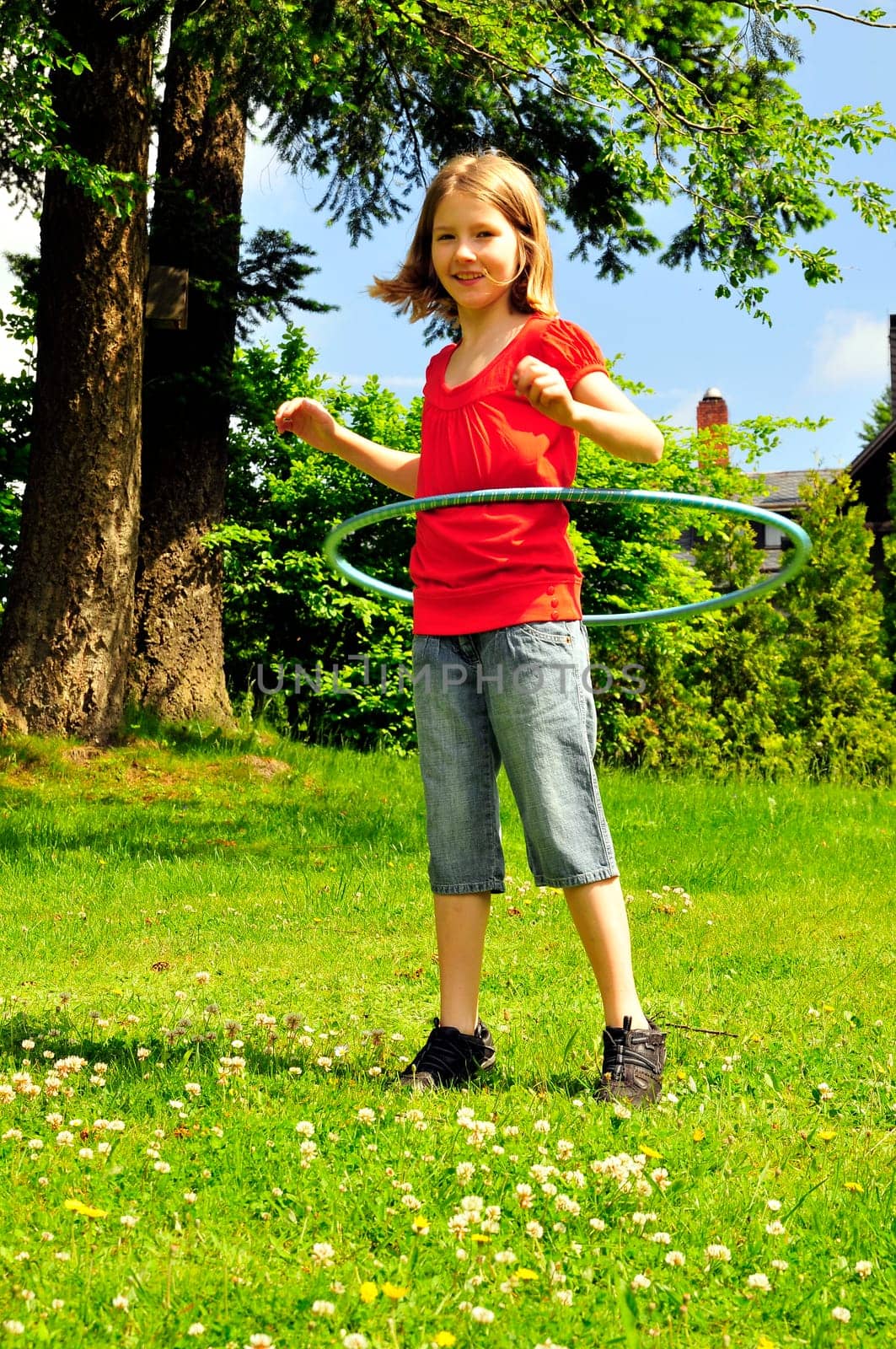 Child in the garden hopping jumping