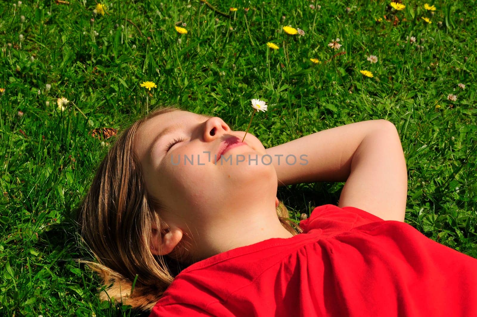 Child lying on meadow
