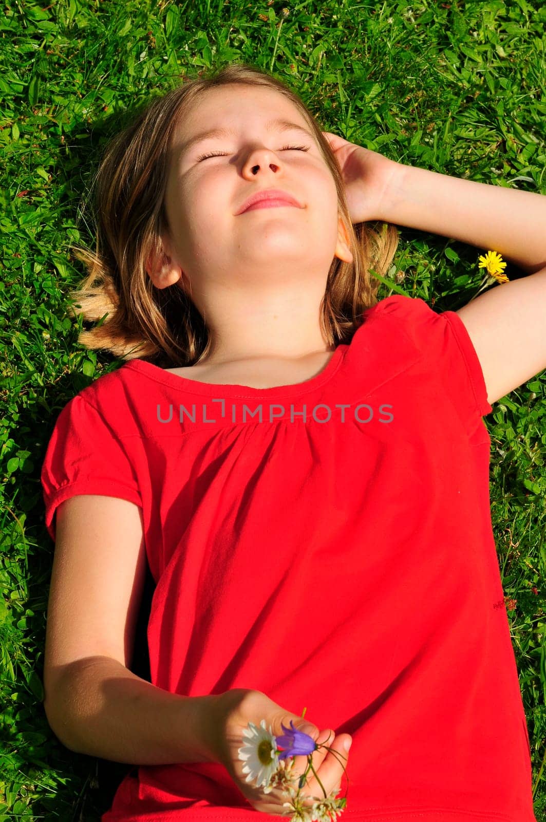 Child lying on meadow