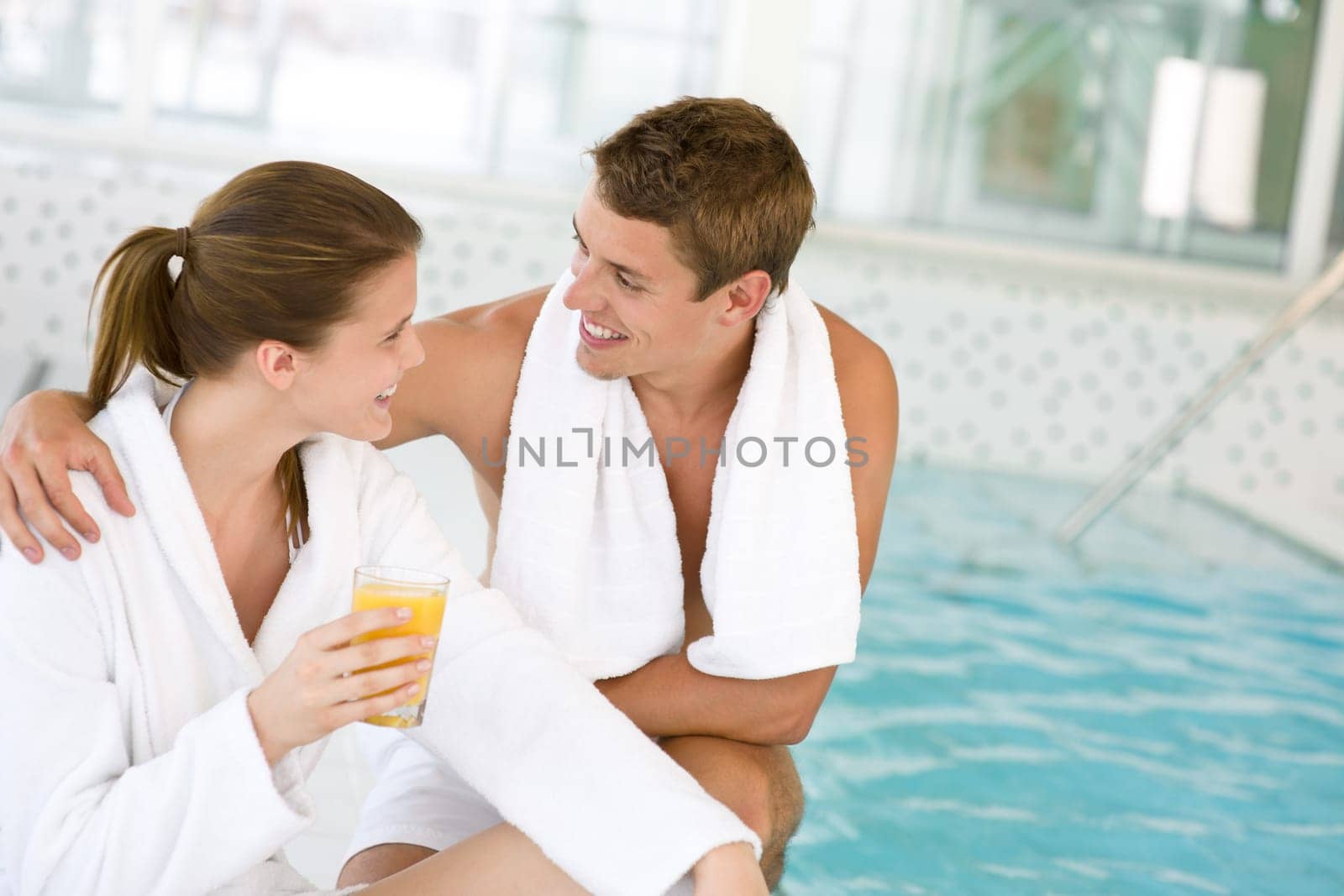 Luxury spa - young couple relax at pool