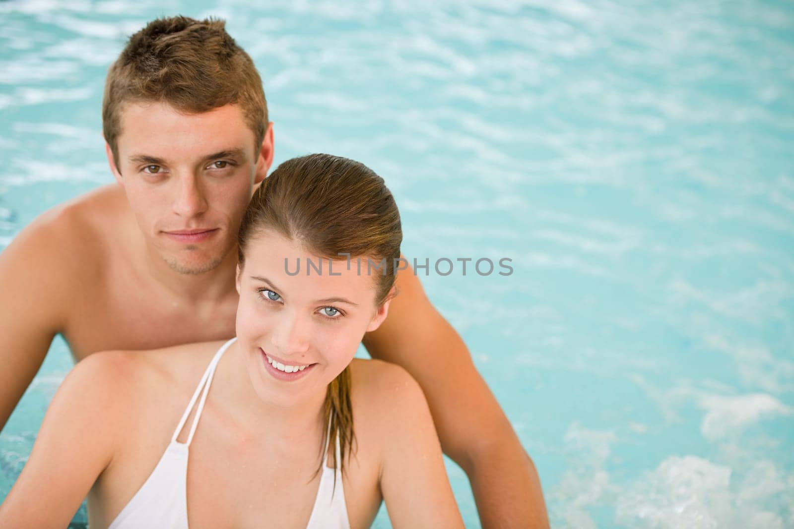 Young sportive couple relax in swimming pool
