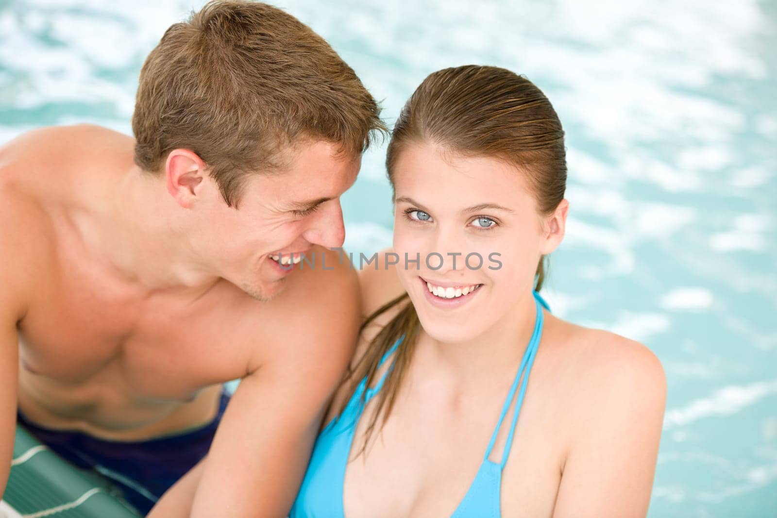 Young sportive couple have fun in swimming pool