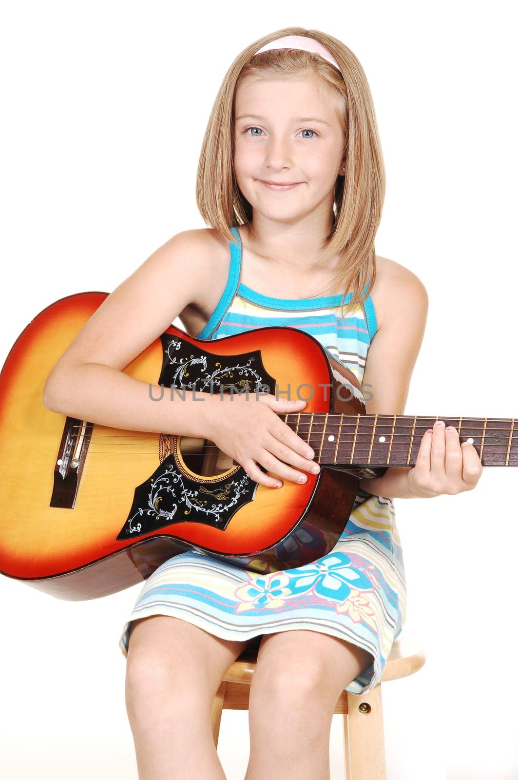 Young blond girl with guitar.