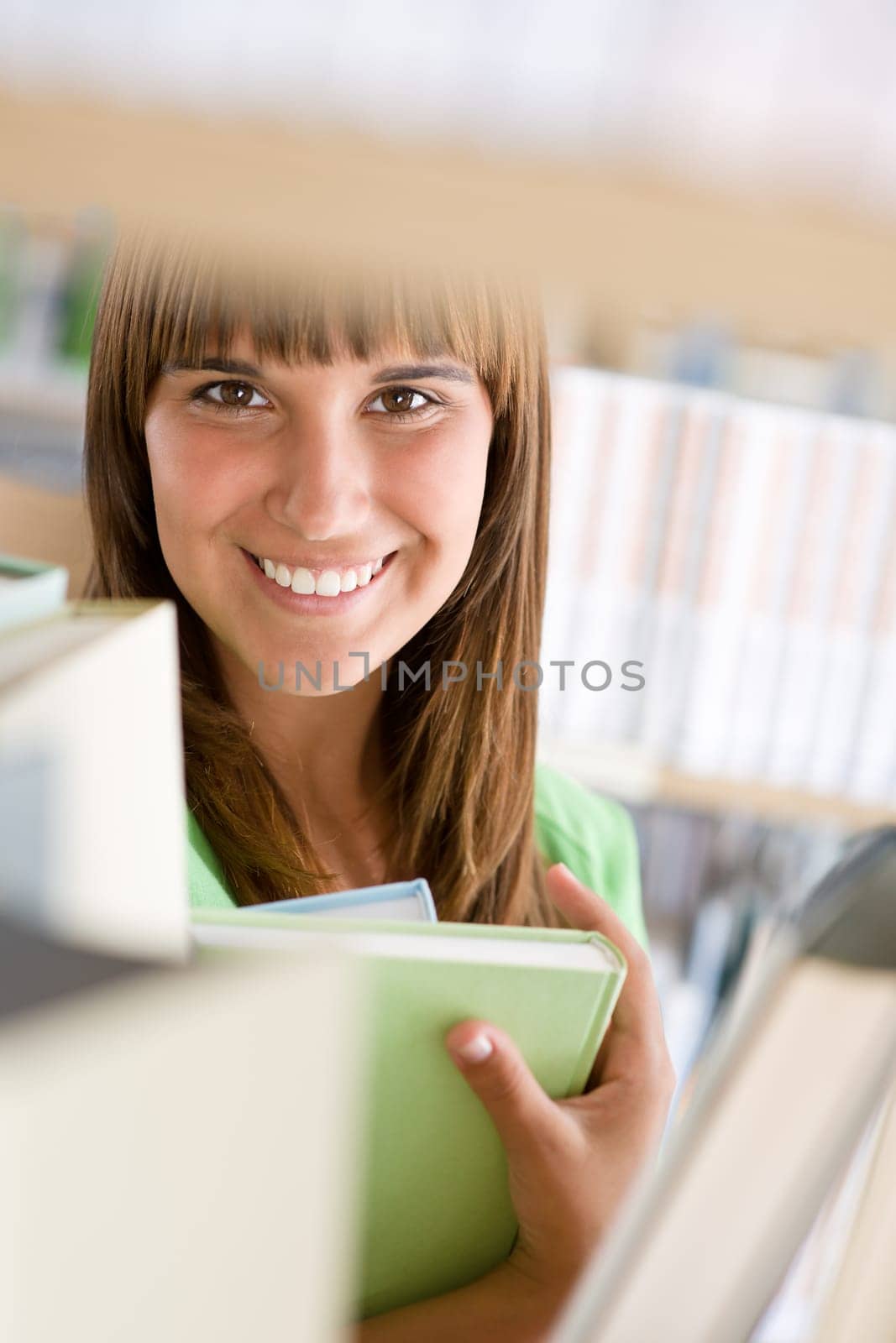 Student in library - cheerful woman hold book
