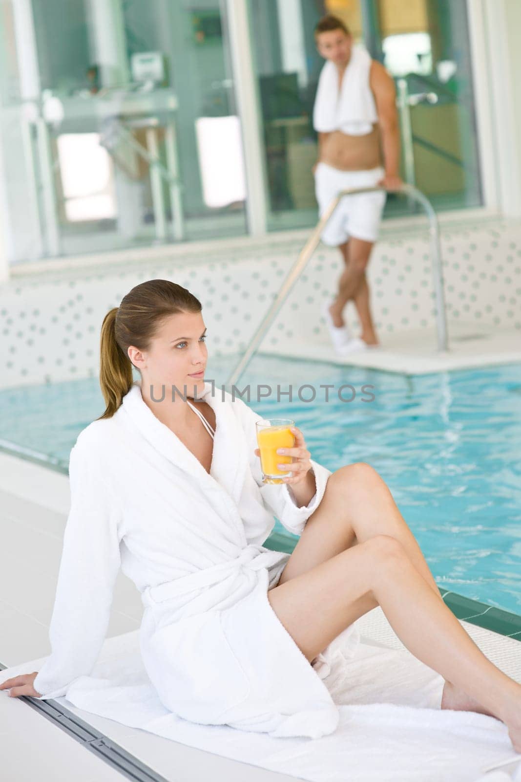 Luxury spa - young couple relax at pool
