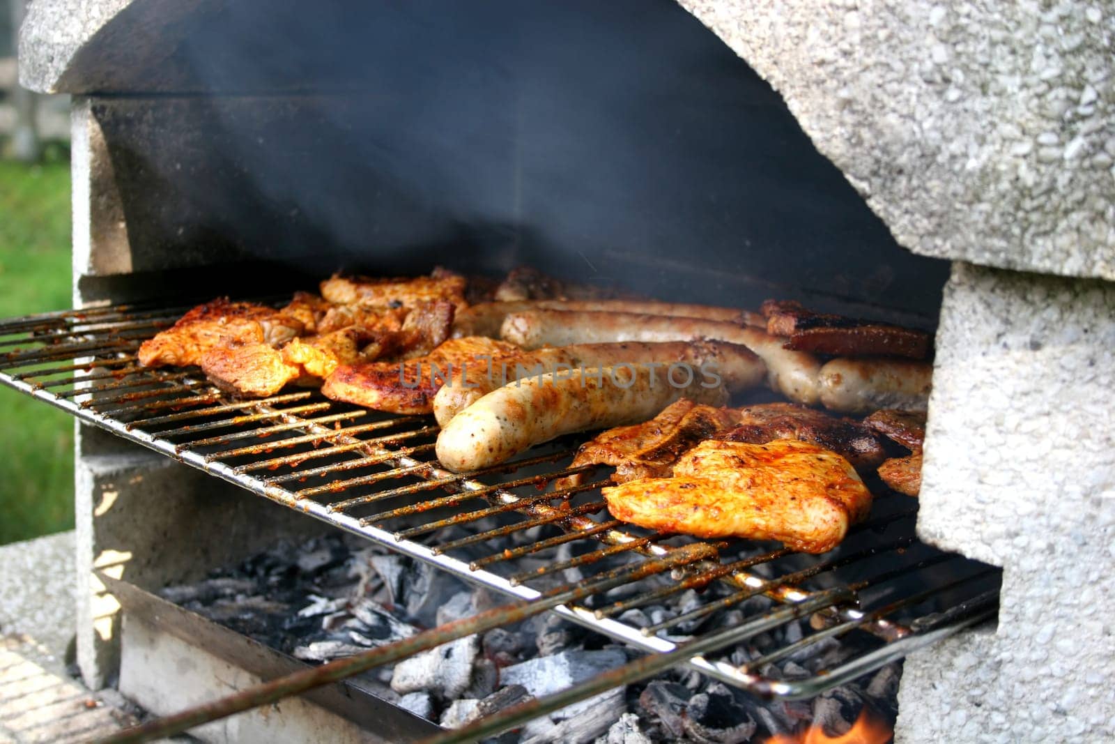 Garden grill with steaks and bratwurst