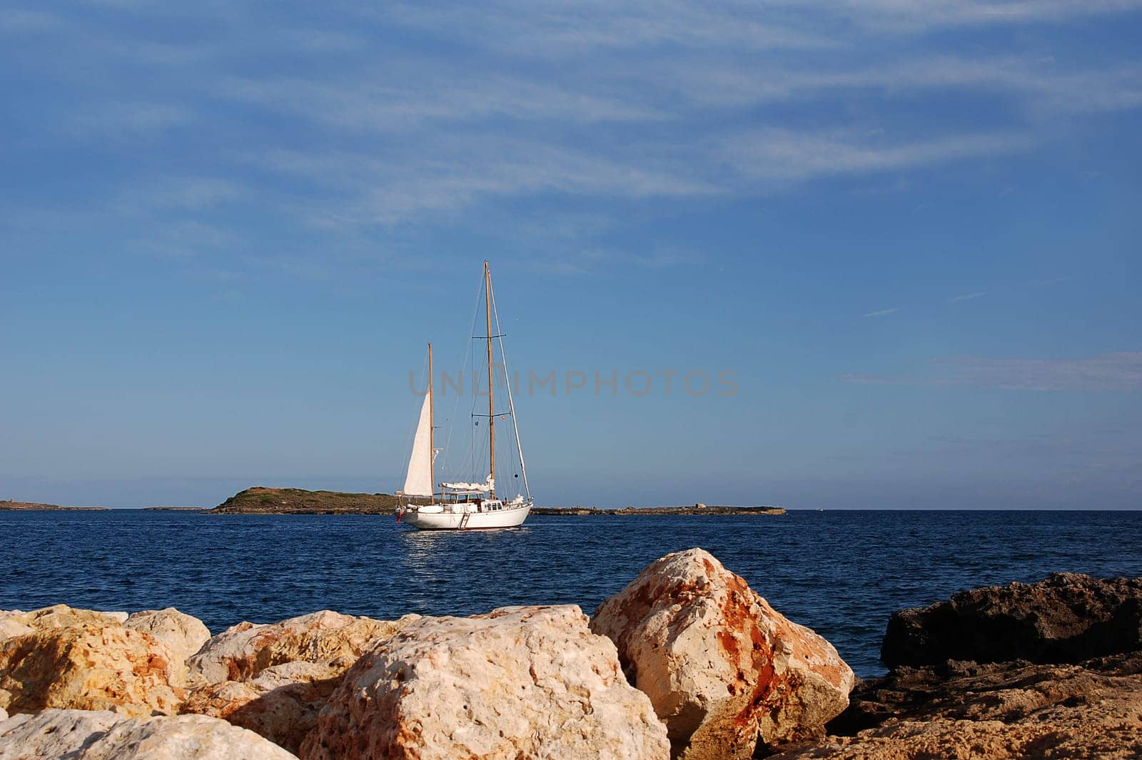 white sailboat off a coast