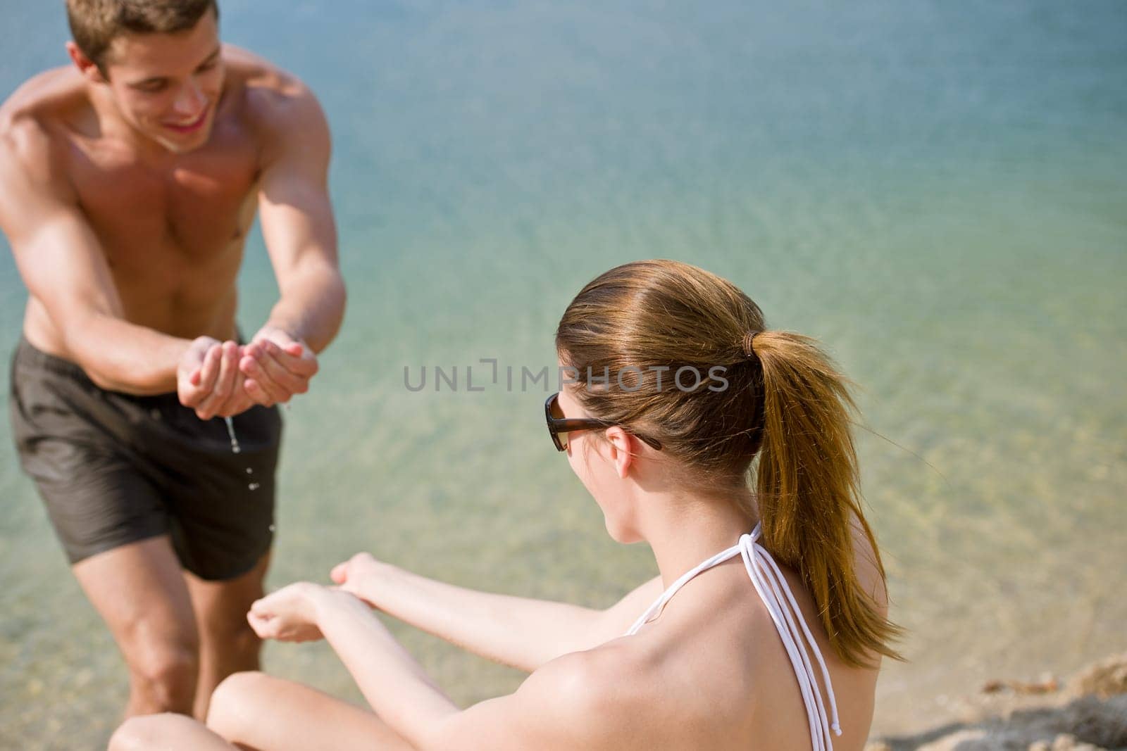 Young couple enjoy summer sun on beach