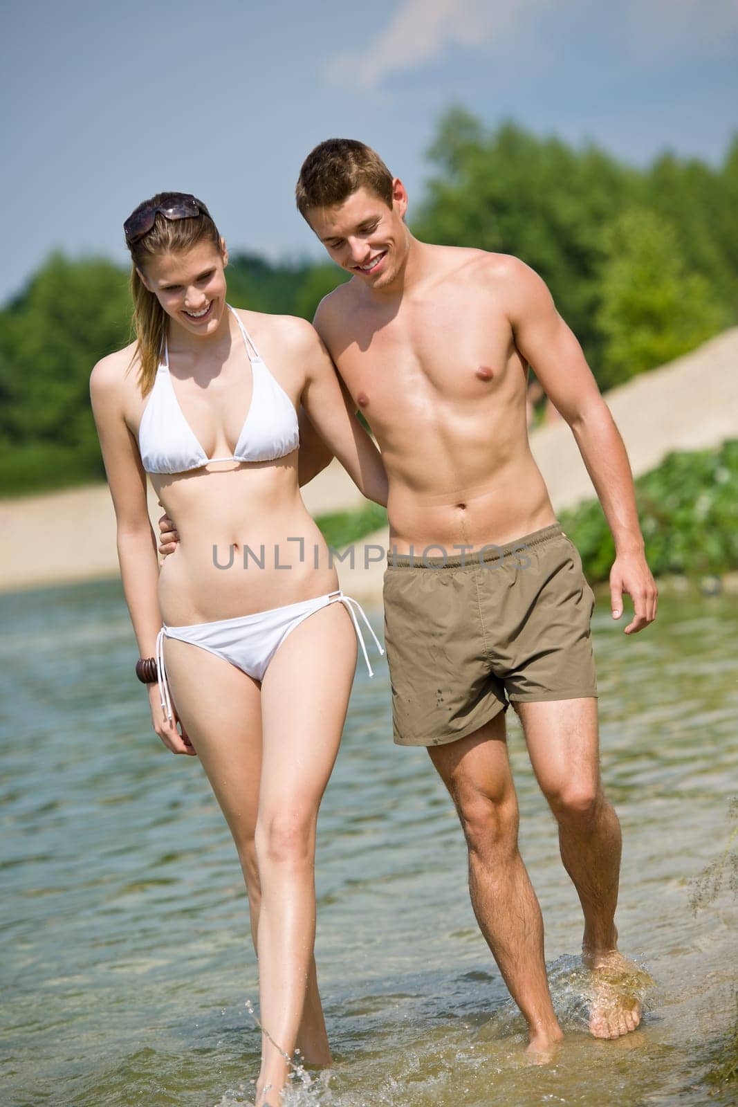 Couple in swimwear enjoy water and sun in summer